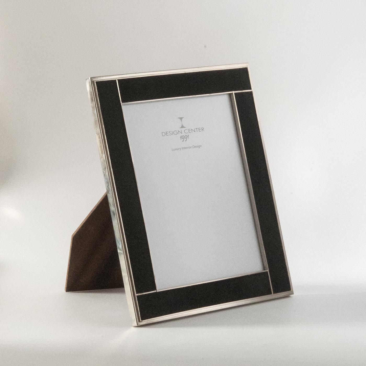 Showcase your most treasured memories atop a desk or console in this elegant picture frame from the Galucharme Black Collection. A piece of exquisite craftsmanship and precious aesthetic that will complement any home décor, the wood frame is covered