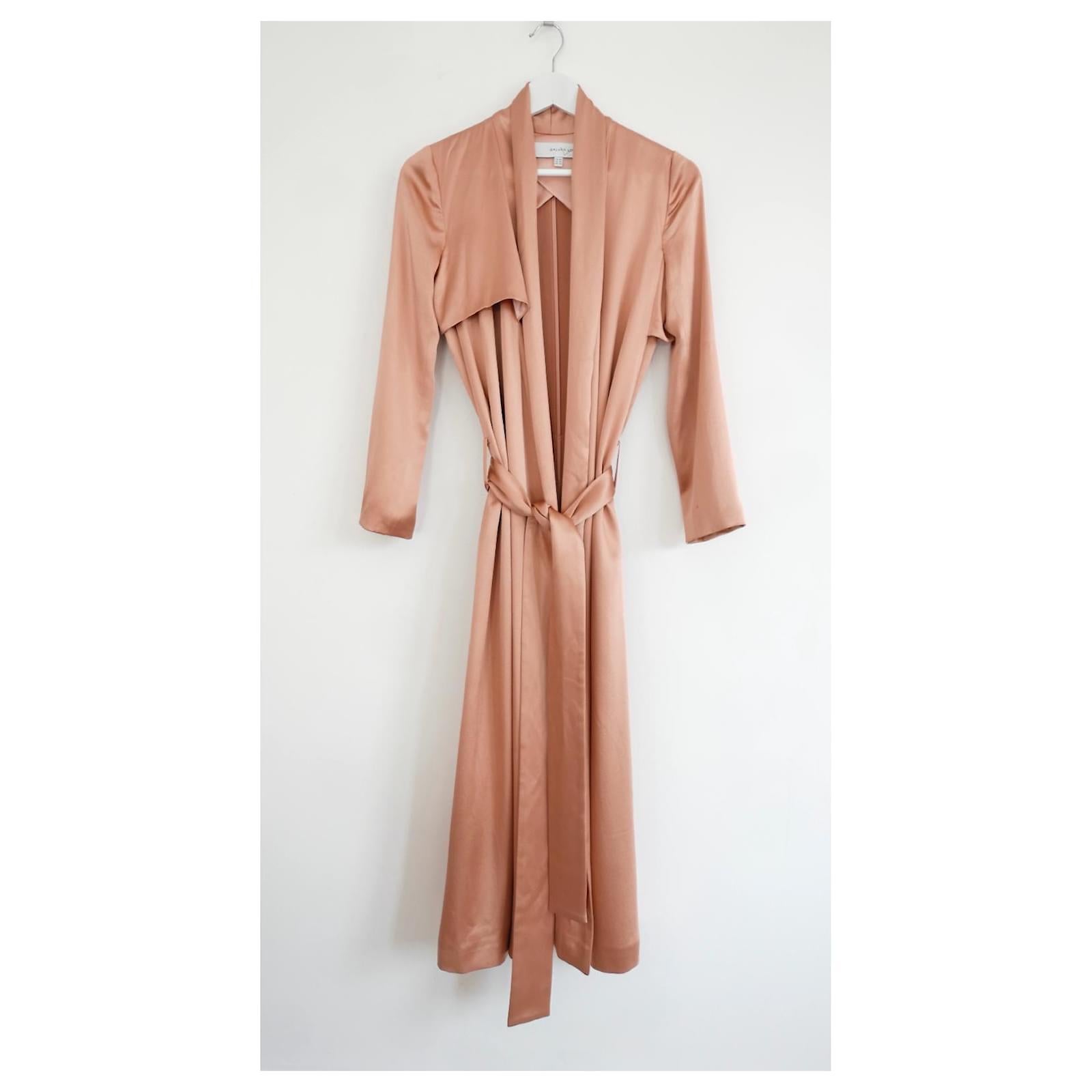 Stunning Galvan satin trench coat. Bought for £1295 and worn a couple of times. 
Made from heavy glossy blush pink silk satin, it has a loose fit with asymmetric yoke detailing and wide belt to fasten at waist. Lined through sleeves and shoulders.