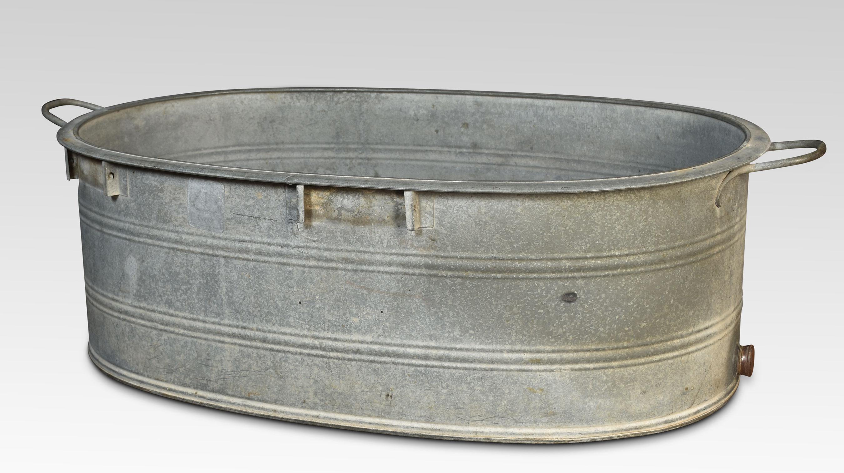 Galvanised tin bath, of oval form fitted with carrying handles and original brass bung.
Dimensions
Height 12.5 Inches
Width 42 Inches
Depth 23.5 Inches