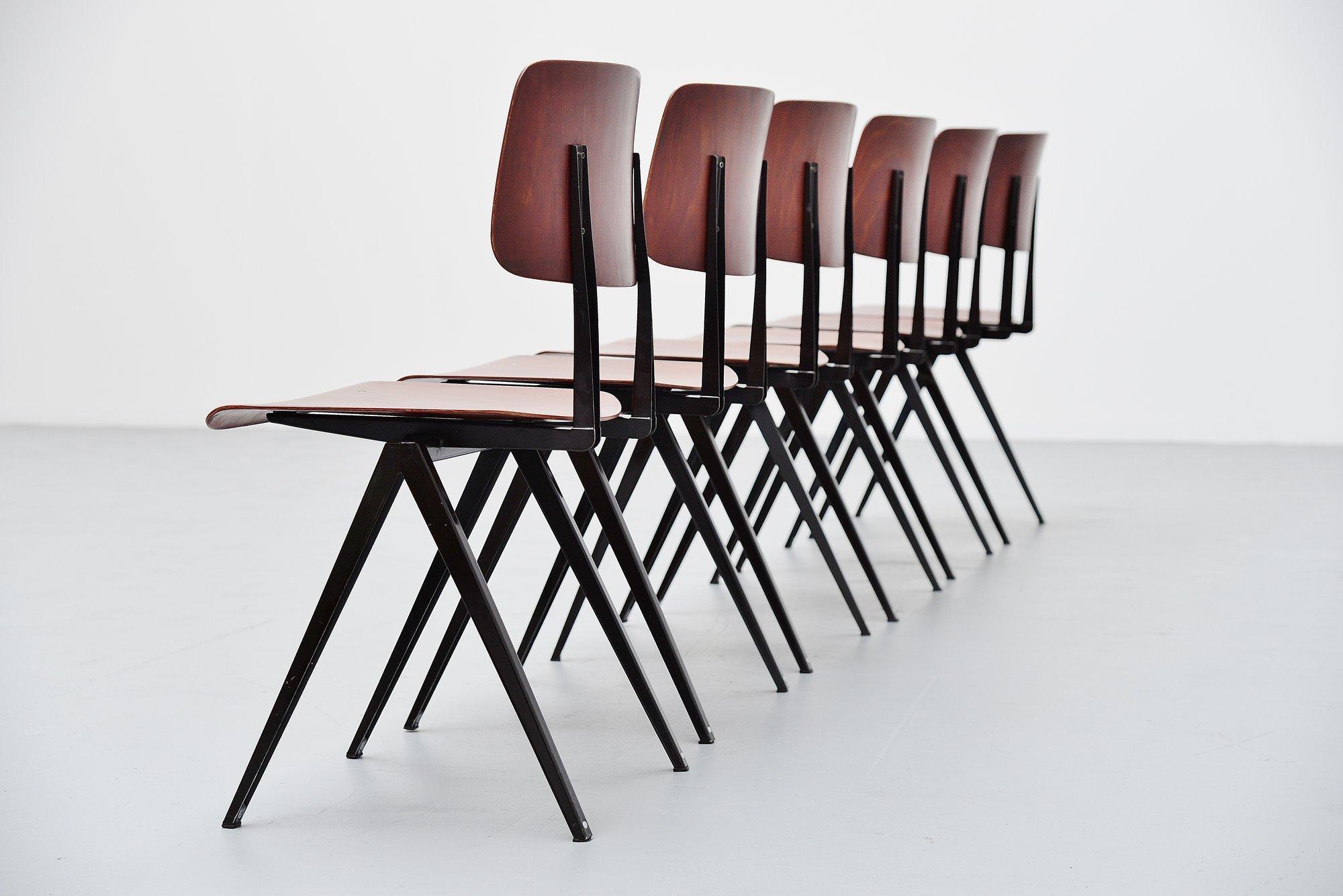 Very nice large lot of industrial chairs model S16 designed and manufactured by Galvanitas, Holland, 1970. These chairs have pagwooden seats and backs, in redbrown color. The U structure frames are painted in black. The chairs are in good original