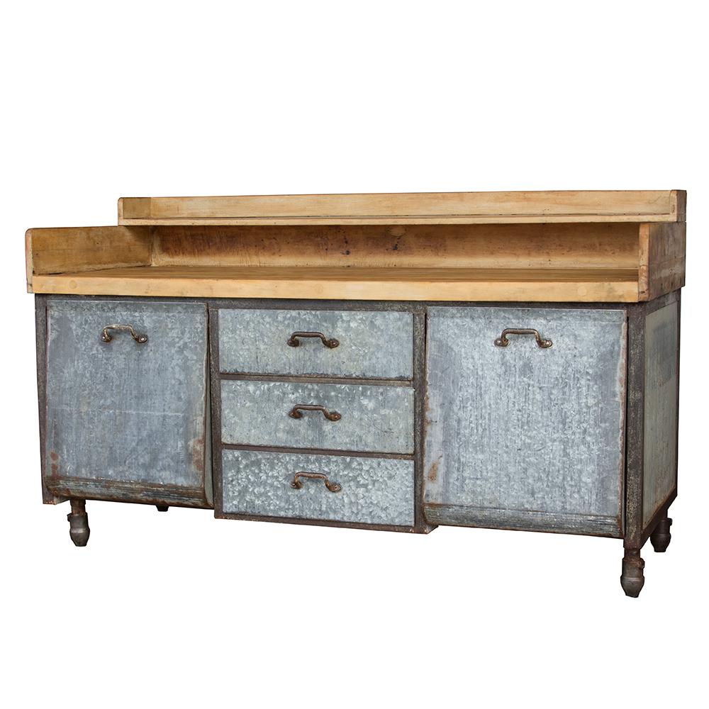 This hefty baker's table has a maple block top and a galvanized base. Tilt-out storage bins and three drawers provide ample storage for any setting.