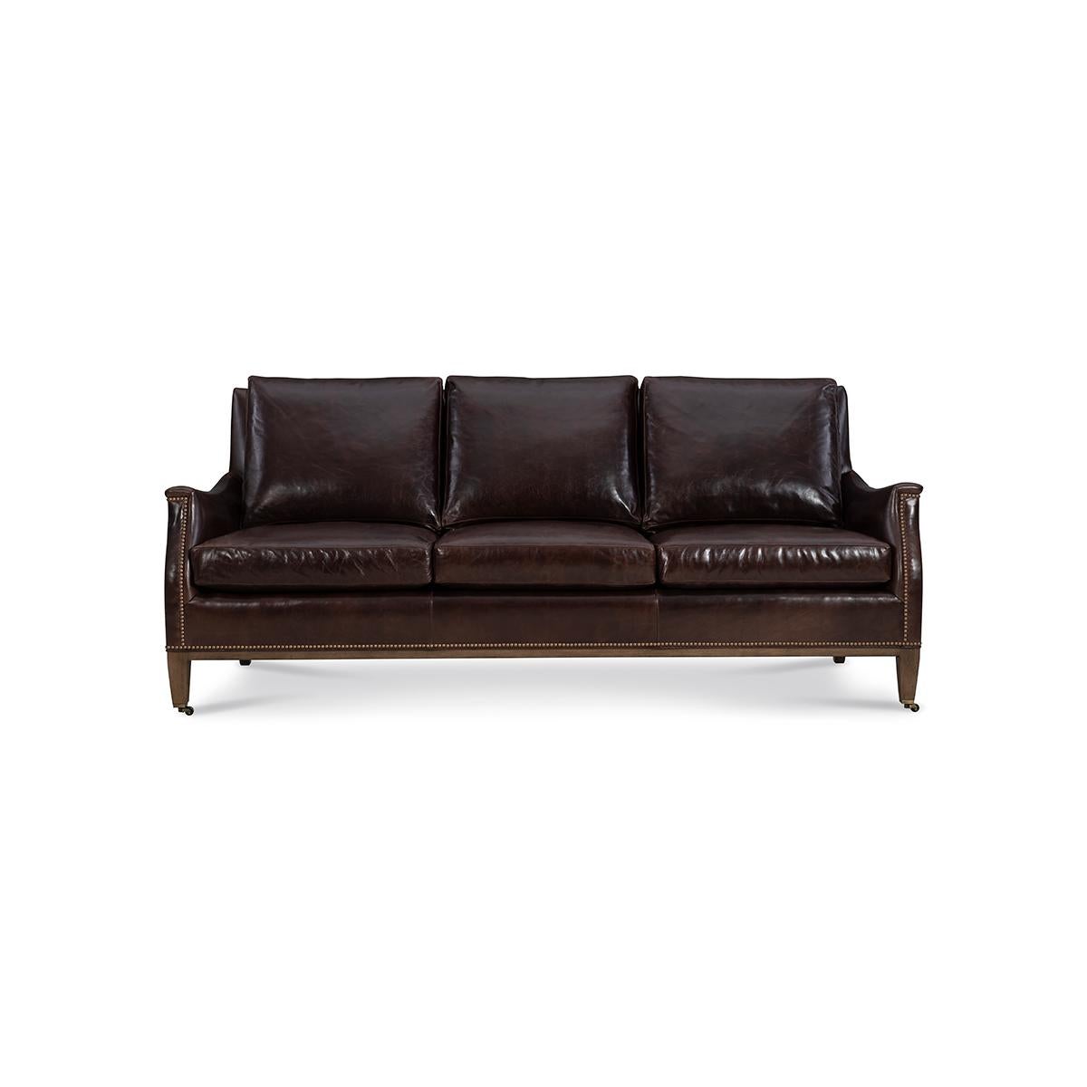 With three loose back cushions and boxed cushion seats, with scrolling arms, raised on square tapered legs, with nailhead trim details.

A classic design that works well with almost any decor. 

Completely Made in USA, with traditional 8-way