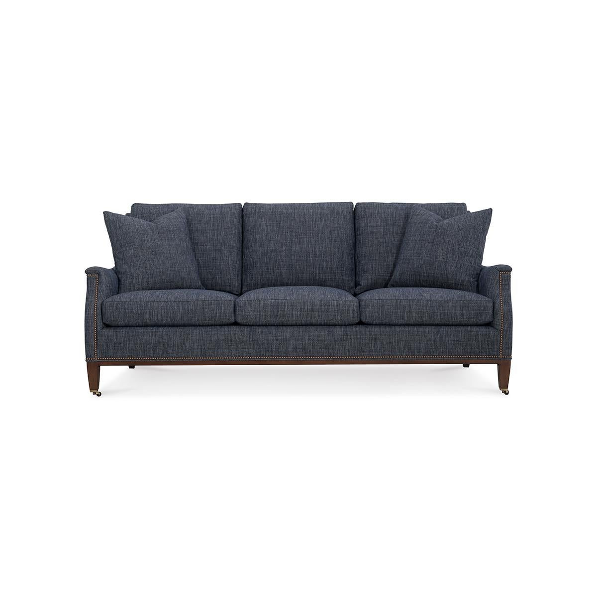 With scrolling arms, raised on square tapered legs, with nailhead trim details.

A classic design that works well with almost any decor. 

Completely Made in USA, with traditional 8-way hand-tied construction, and US grown - toxin-free - kiln-dried