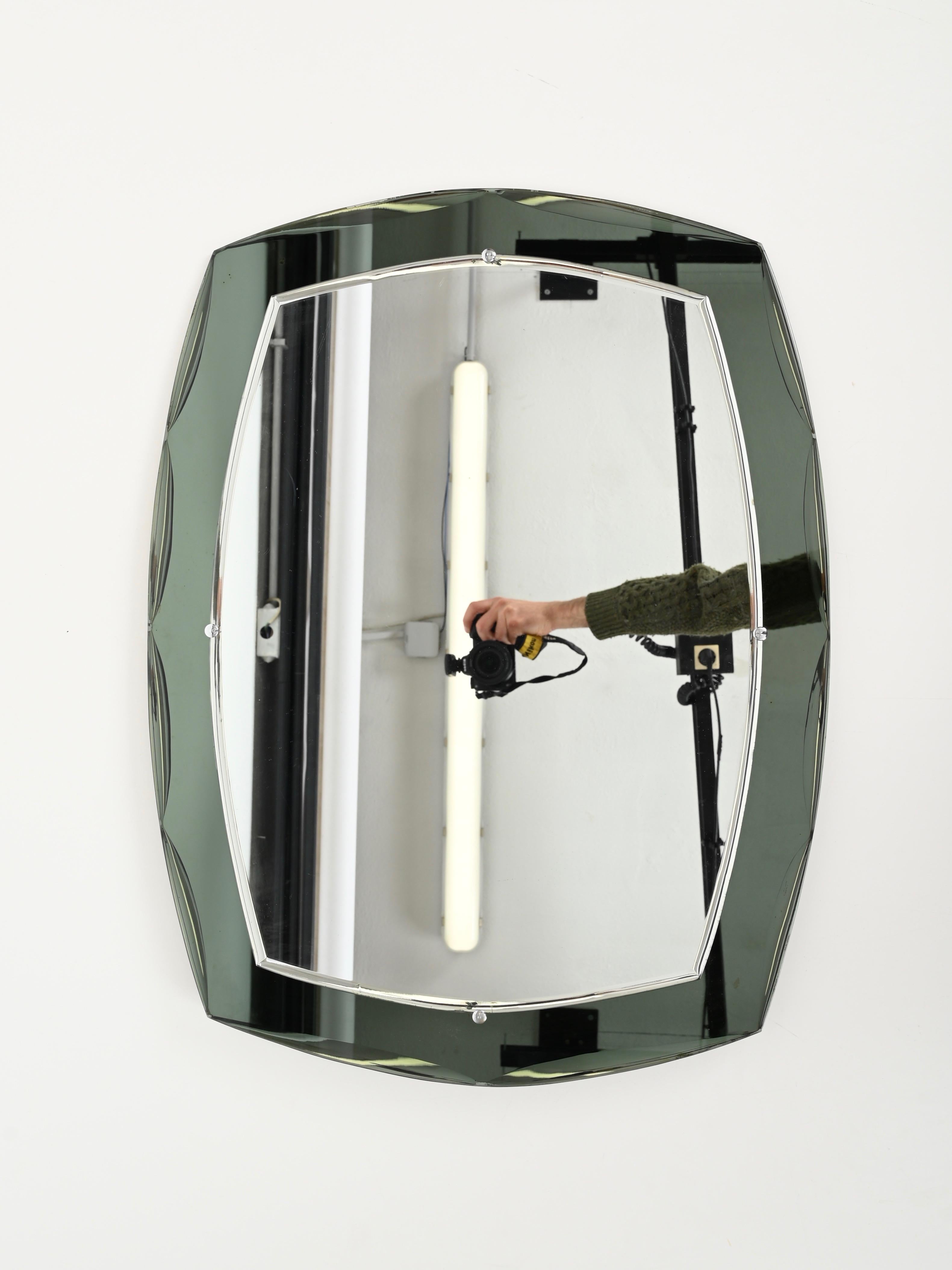 Gorgeous rectangular double beveled mirror with a wonderful grey-green mirror frame. This charming mirror was produced by Metalvetro Galvorame in Italy during the 1960s.

This stunning mirror has a sage colored crystal mirror frame that shades from