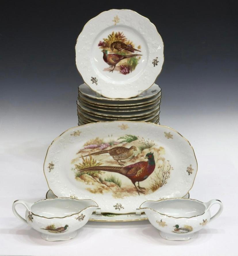 A hard to find antique porcelain service for 24 featuring assorted game birds on a finely shaped and raised floral Limoges France blank. A combination of hand coloring and stencil with parcel gilt shaped edges. This set is 28 pieces total and