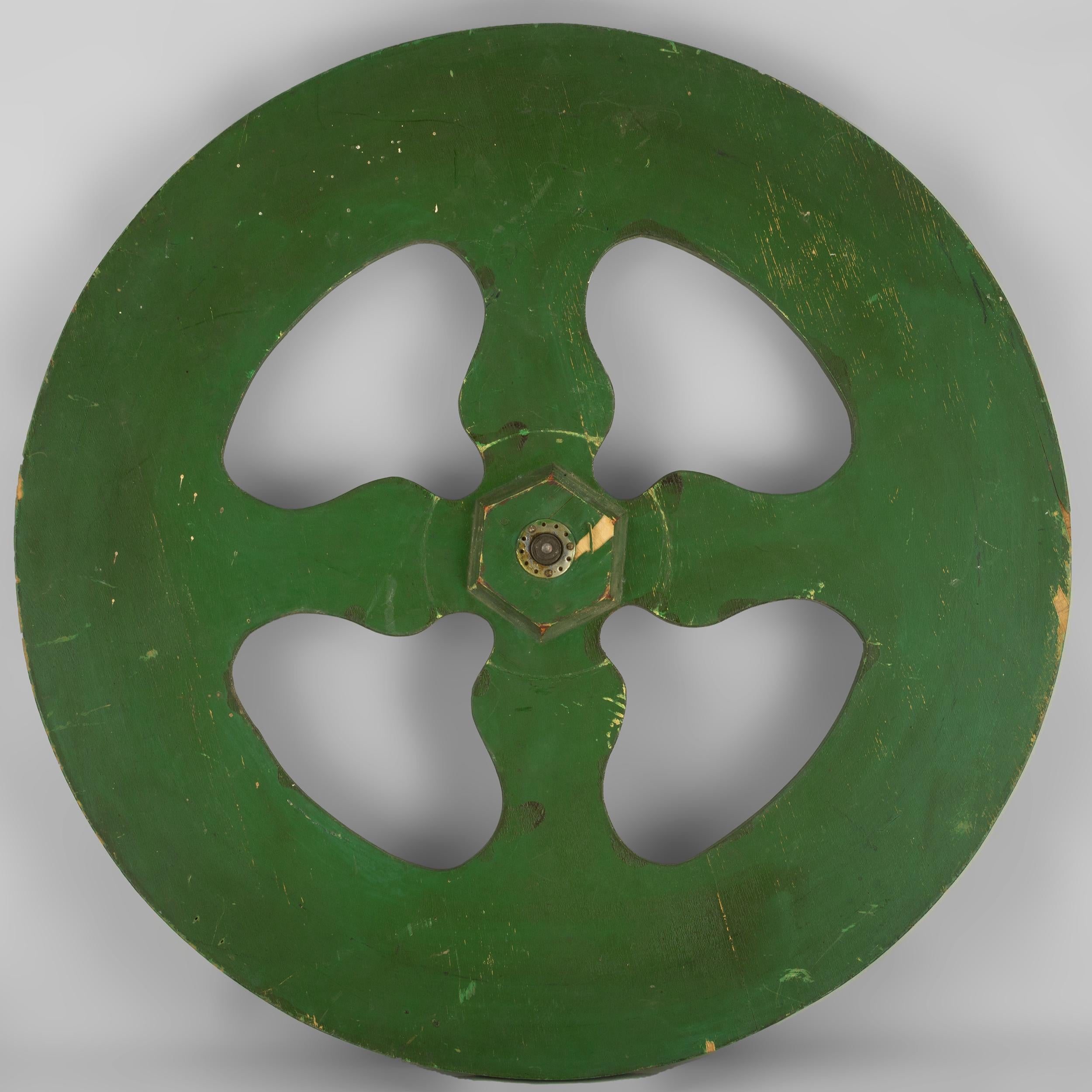 Game of chance gaming wheel
vibrantly painted with red, yellow,
green and black with 20 randomly
ordered numbers. The center cut
out with four variform spokes and a
brass central hub. American, circa 1920.
 