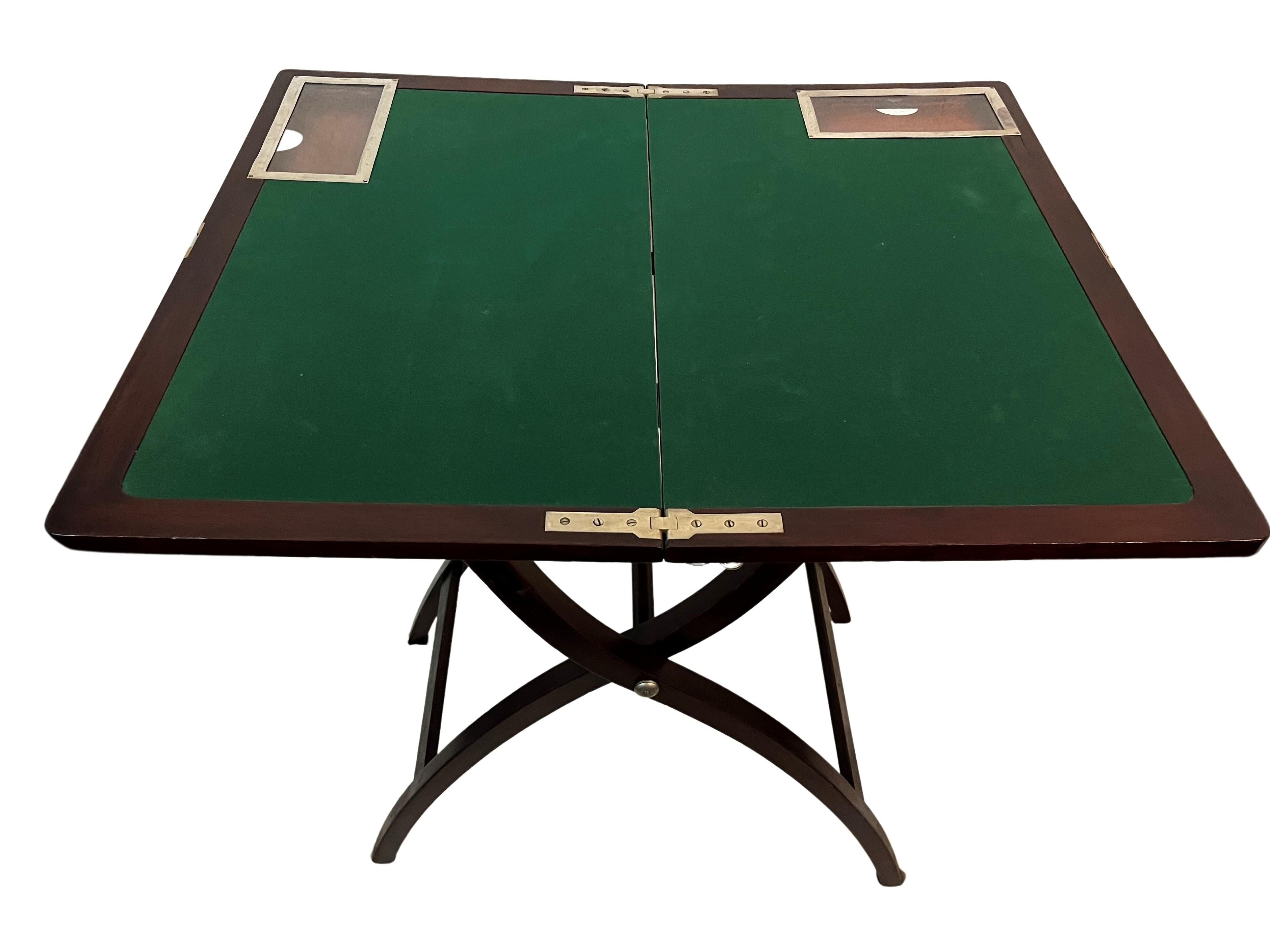 Very rare gaming table, with a fascinatingly executed folding mechanism. This object was made in England, around 1920, in the Art Deco period.

When unfolded, a playing surface appears that is lined with green felt. There are two small drawers,
