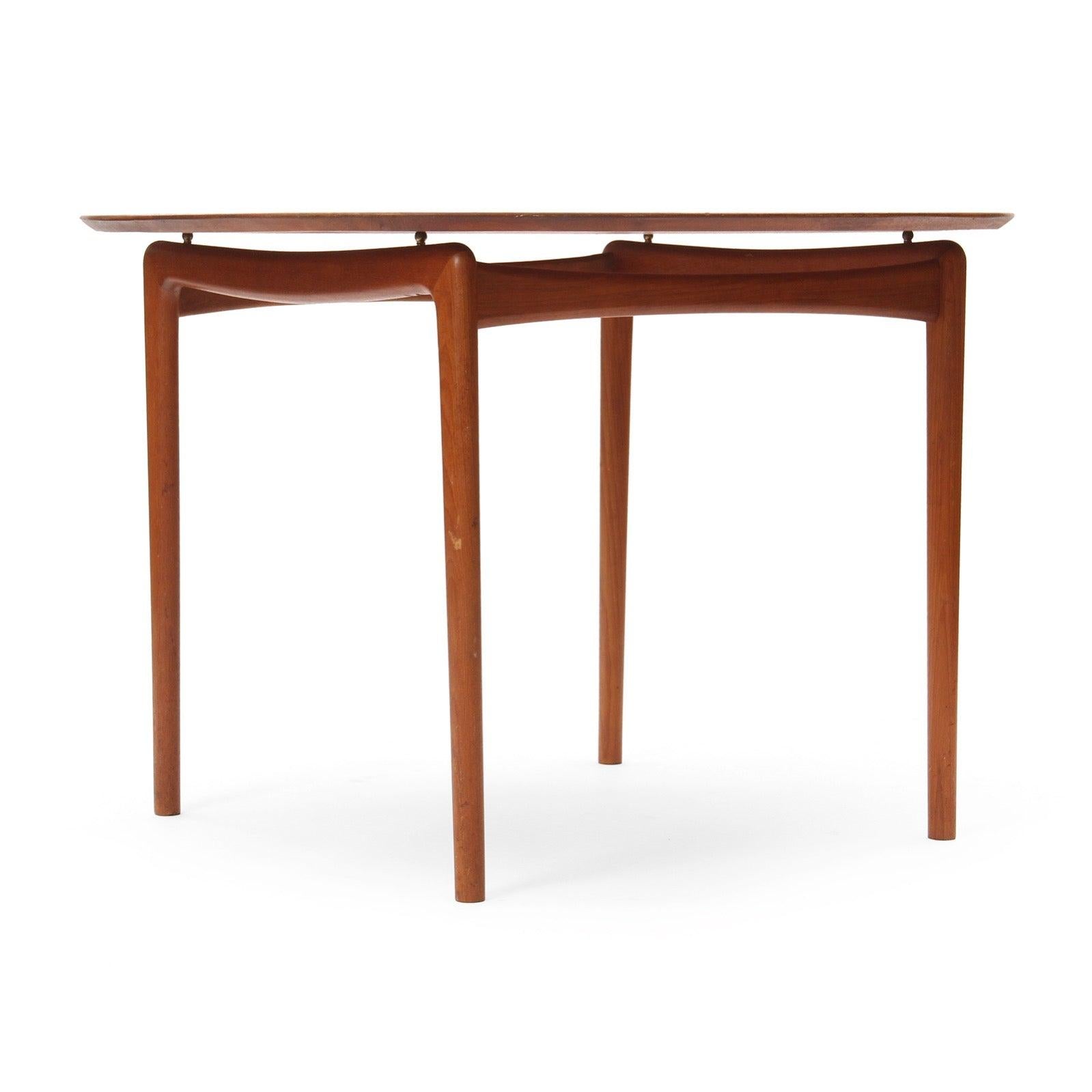 A solid teak round dining table.