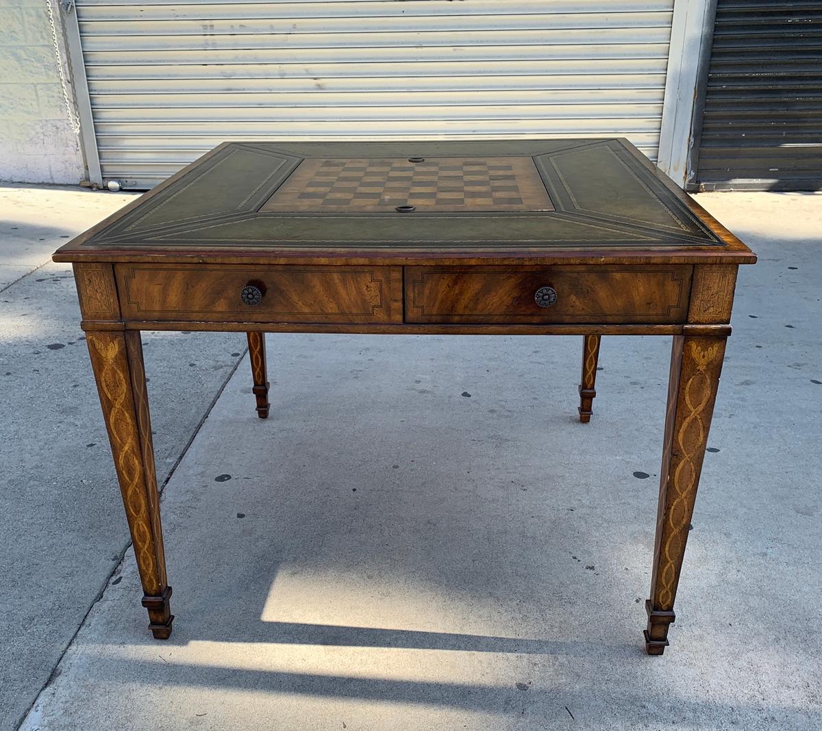 Stunning and beautiful game table wrapped in leather and parquetry detail designed and hand made in the Philippines by Maitland Smith.

The table shows beautifully, the table has 4 drawers, and an inset for chess set.

The piece is in very good