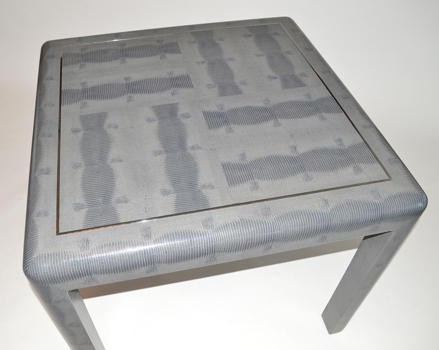 Game table in lizard skin by Karl Springer, 1980's, signed. Embossed leather covered lizard skin and chrome parsons-style game table with leather Karl Springer tag.
     