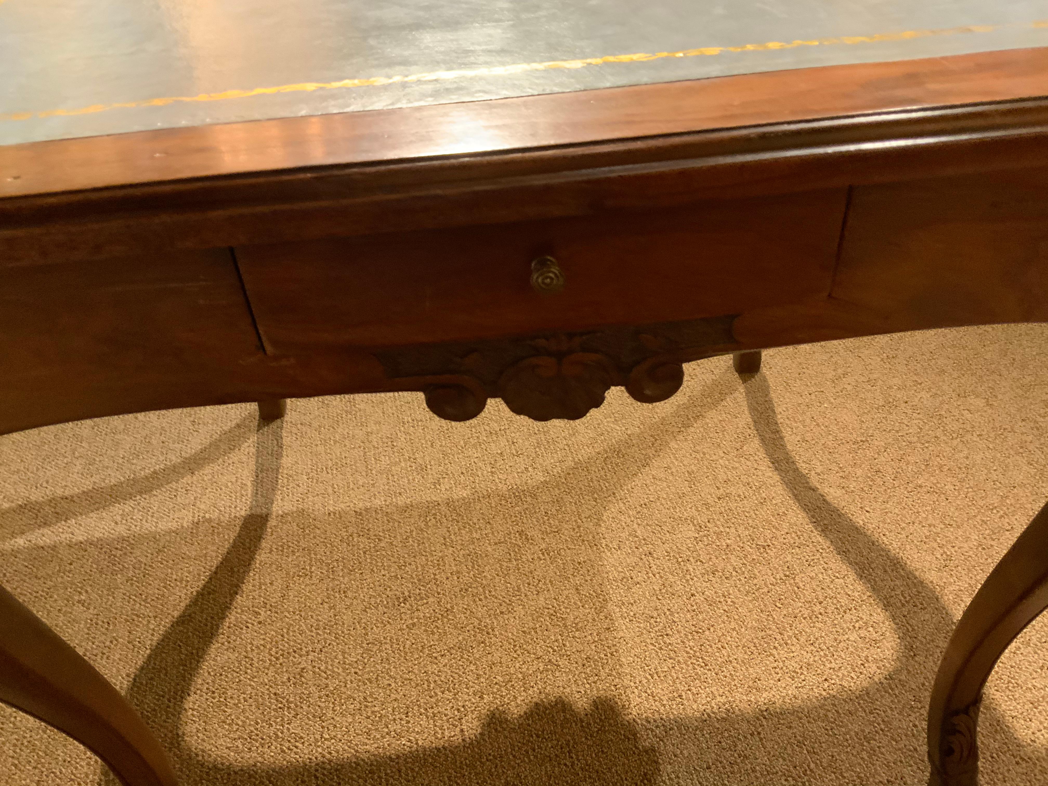 Handsome game table with leather top having gilt trim. Curved graceful leg and has
A small drawer on each side.