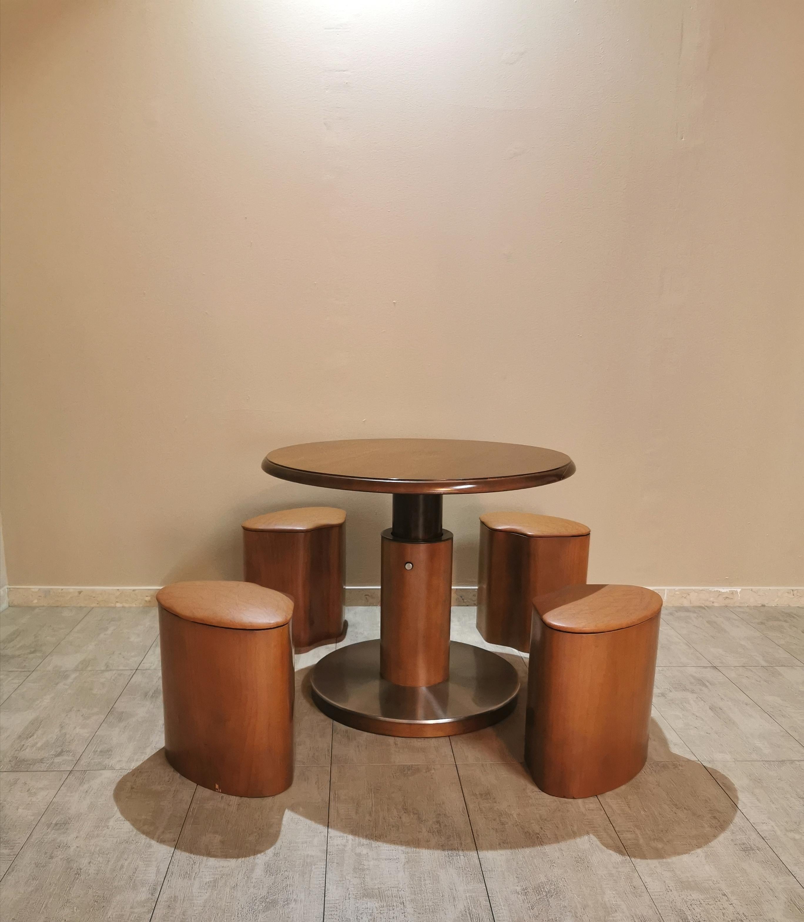 Particular round wooden small game table with aluminum base covering. The peculiarity of this game table consists in the movement in height through a button positioned in the central axis. Includes 4 wooden stools with eco-leather upholstery that