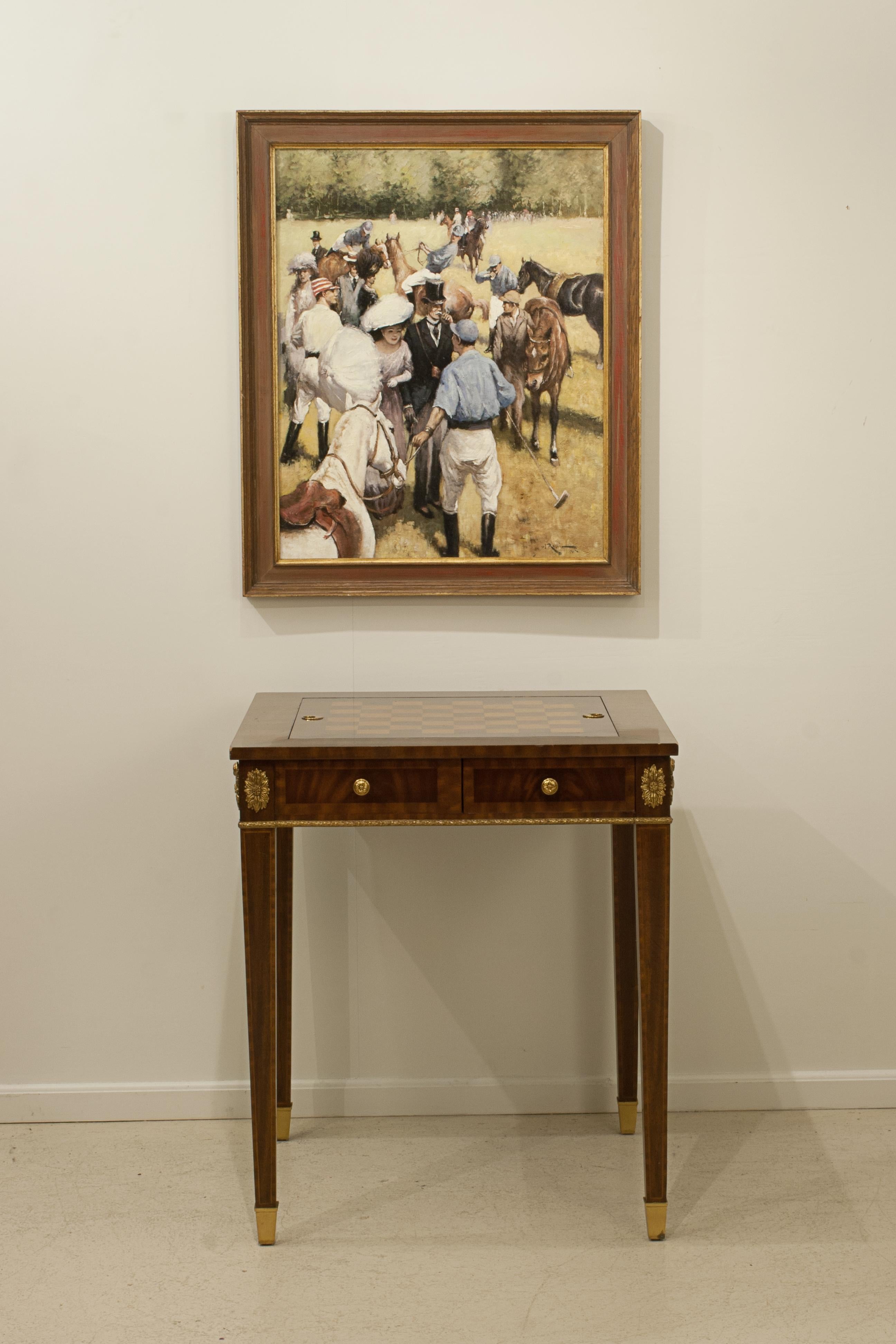 Reversible Maitland-Smith Georgian Style Mahogany Game Table.
A reproduction Georgian style reversible chess, draughts and backgammon games table. The mahogany table with four tapering legs with brass cup feet, table with brass accents throughout,