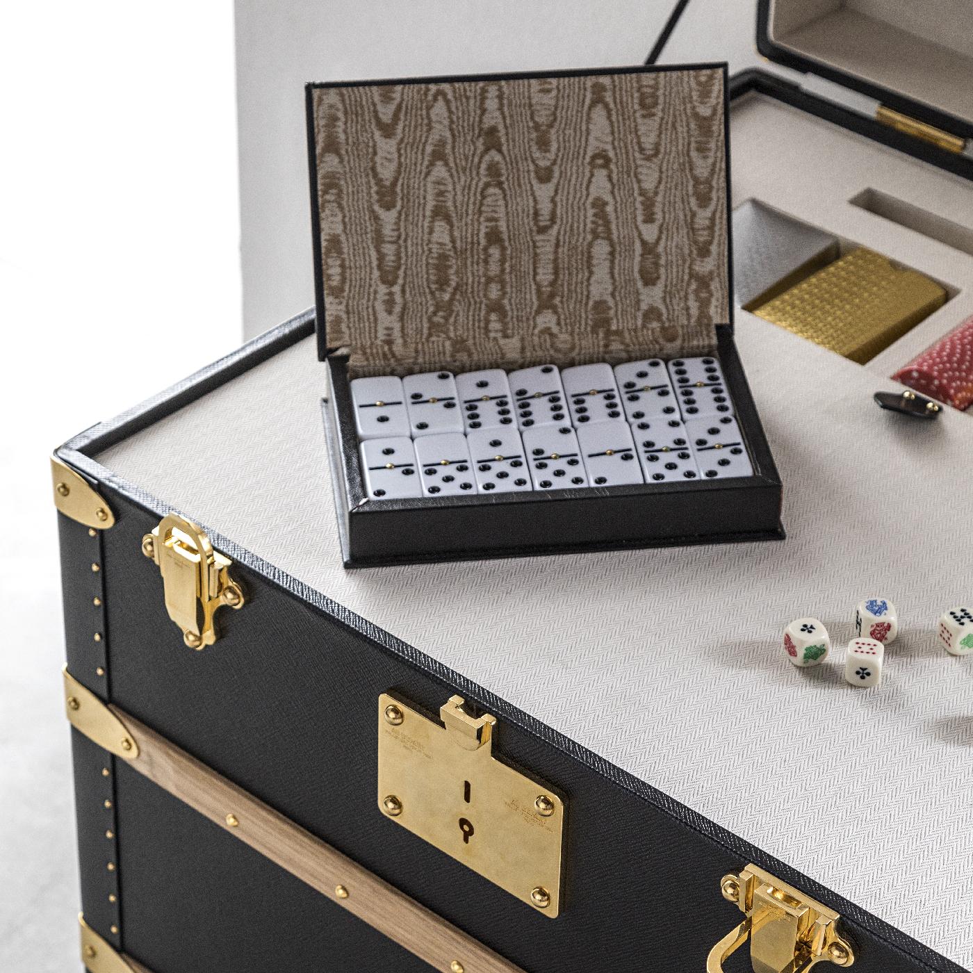 Part of the Music and Games collection, this elegant trunk combines a modern aesthetic with the old-fashioned allure of Classic board games, conveniently stored all in one place. The elegant and spacious piece includes cards and fiches games, a