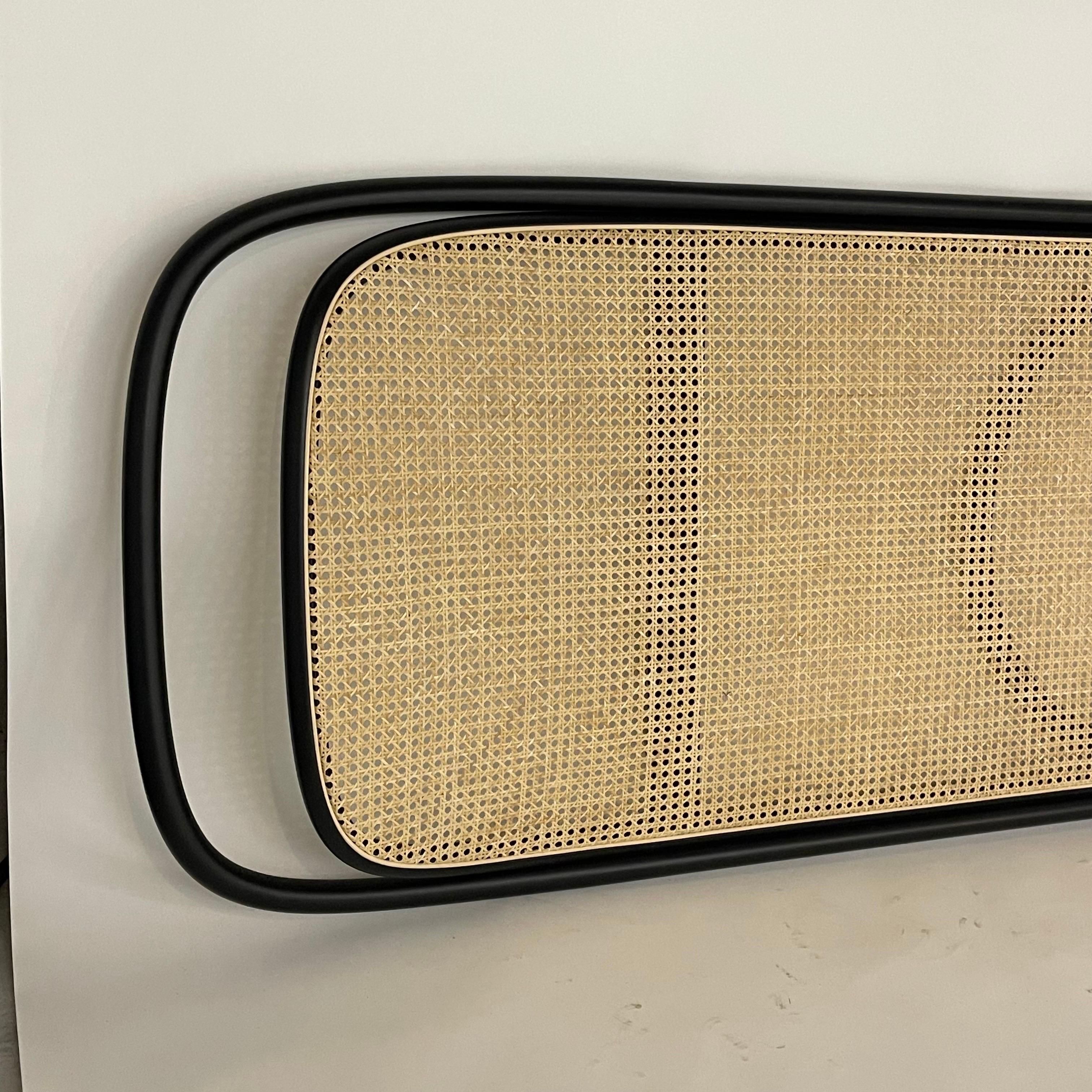 Rue Headboard wall mounted, rendered in black painted bentwood frame with cane upholstery (finish C01 - C01 - RAL 9005 Black, Cat. C cane upholstery) designed by GamFratesi for Gebrüder Thonet Vienna, Itay, 2019.