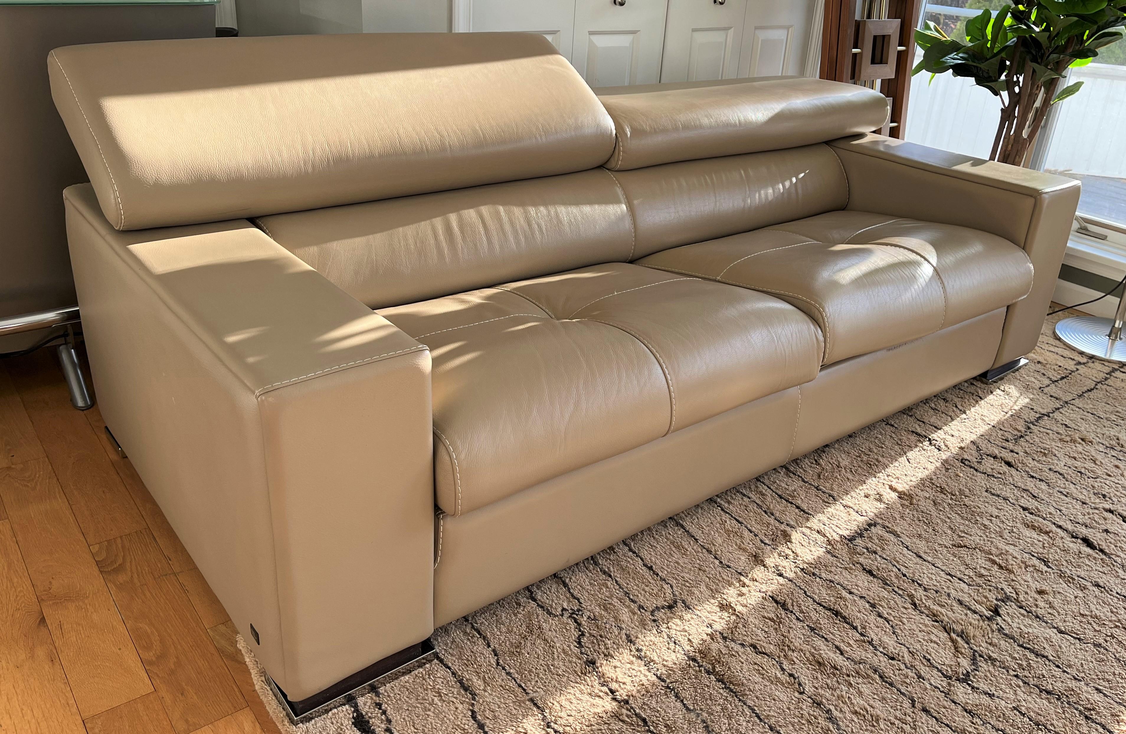 Gamma Arredamenti leather sofa in beige color. Legs have a dark brown finish to wood & chrome finish to metal. Solid wooden frame. Back cushions with individual headrest mechanism.


