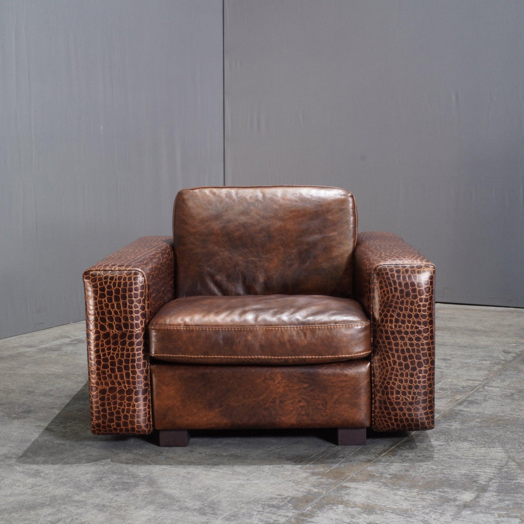 Introducing the Gamma Arredamenti Brown Crocodile Leather Kelly Armchair—a luxurious embodiment of Italian craftsmanship. This distinctive armchair merges timeless elegance with bold design elements, featuring rich, textured crocodile-embossed