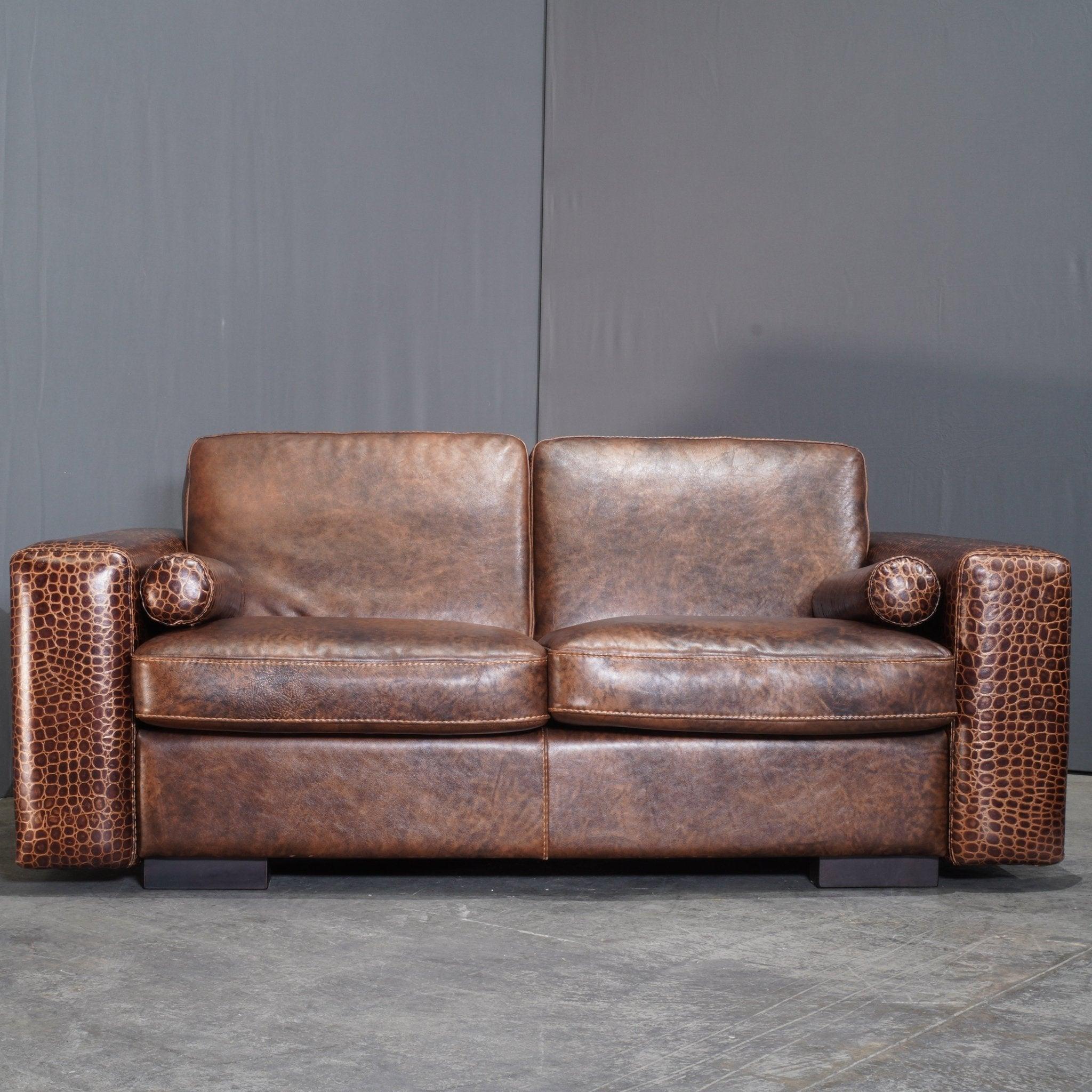 The Gamma Arredamenti Crocodile Leather 2 Seater Kelly Sofa is a bold statement piece that exudes luxury and sophistication. Upholstered in exquisite brown crocodile-patterned leather, this sofa perfectly balances contemporary design with artisanal