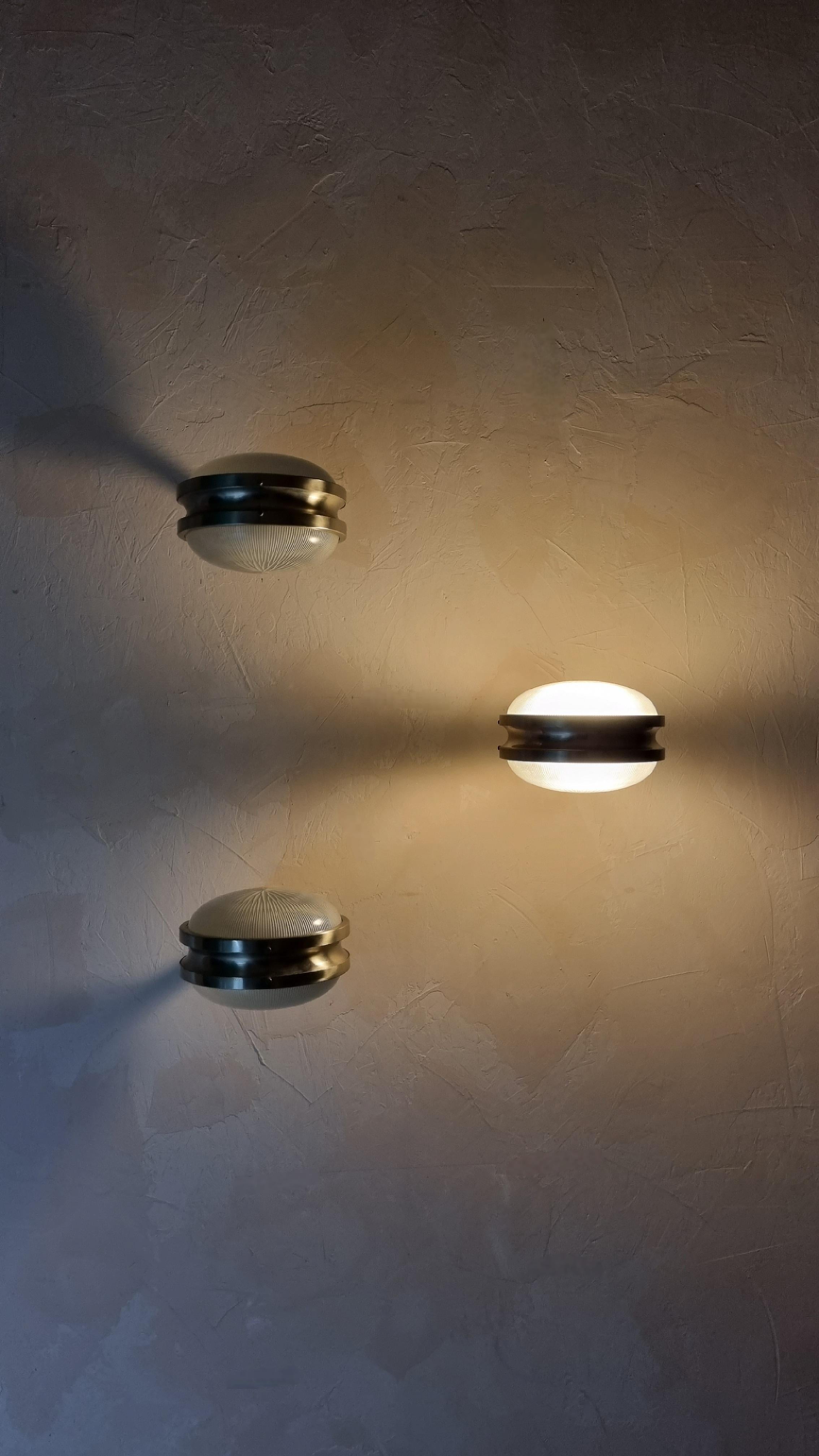 Set of 3 Gamma wall sconces designed by Sergio Mazza for Artemide in the 1960, pressed crystal diffusers , structure in nickel-plated brass, each lamp  superimposed 2 light points that emit a warm and soft light. mounts E 27 bulbs.
Excellent