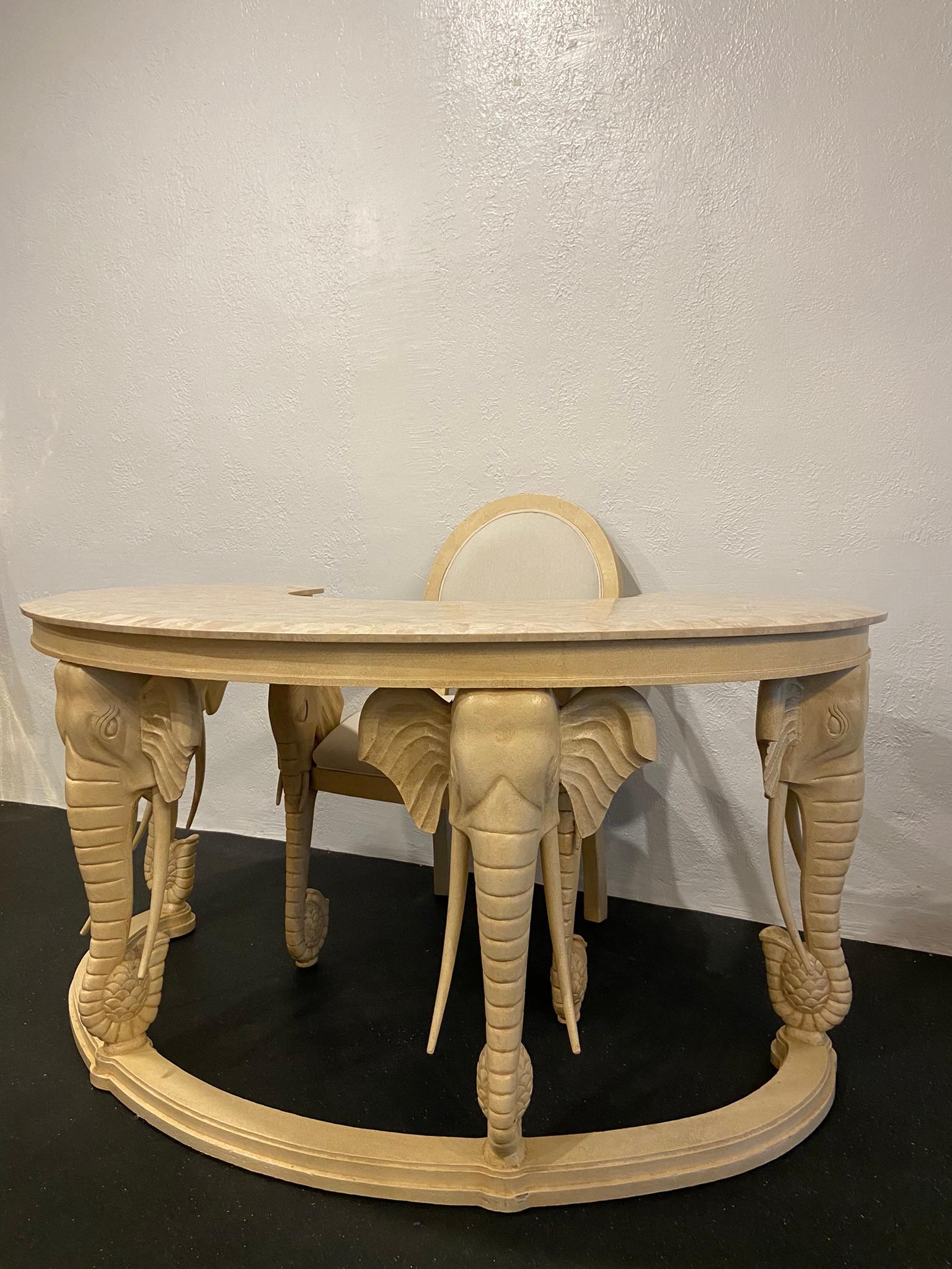 Stone top carved elephant desk and matching chair. All tusk are completely removable for safe transportation. Reupholstery is recommended on the chair. No chips or nicks to the stone top, a few areas of wear to the painted finish (please refer to