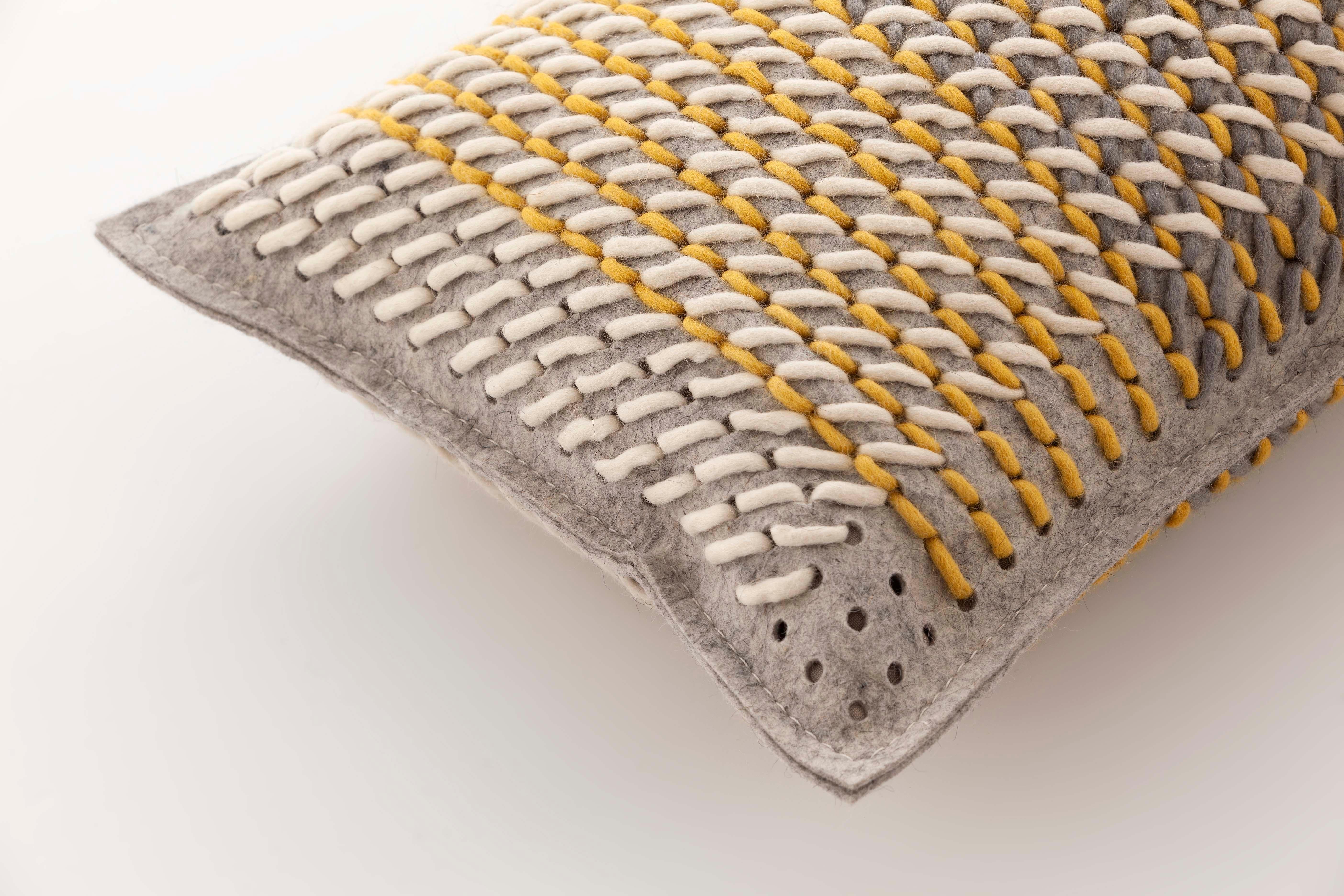 A completely different application of the possibilities offered by the technique devised by Charlotte Lancelot for the Canevas collection. Using the same cross stitch technique produced with coloured wool threads on a perforated felt base, Canevas