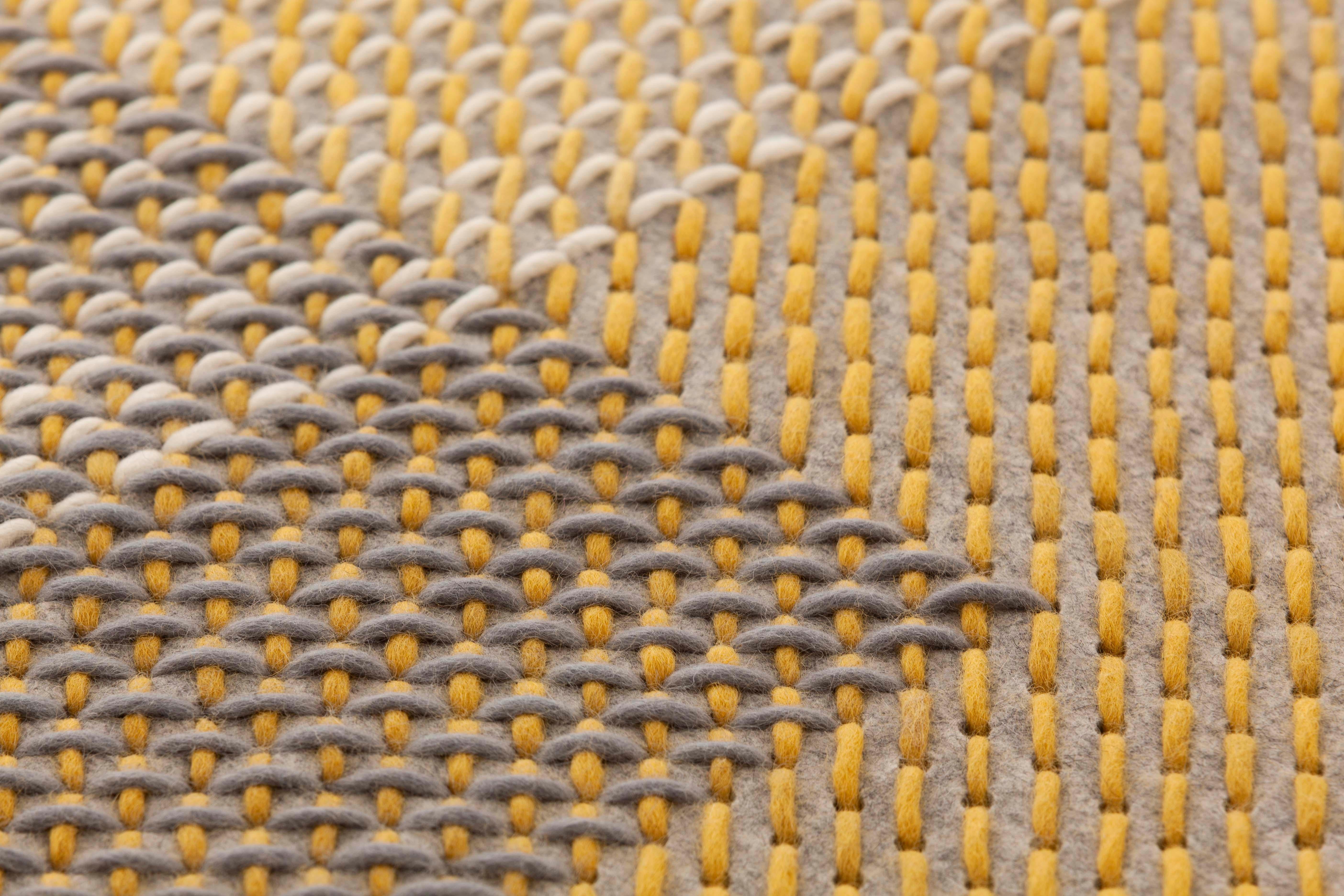 A completely different application of the possibilities offered by the technique devised by Charlotte Lancelot for the Canevas collection. Using the same cross stitch technique produced with coloured wool threads on a perforated felt base, Canevas