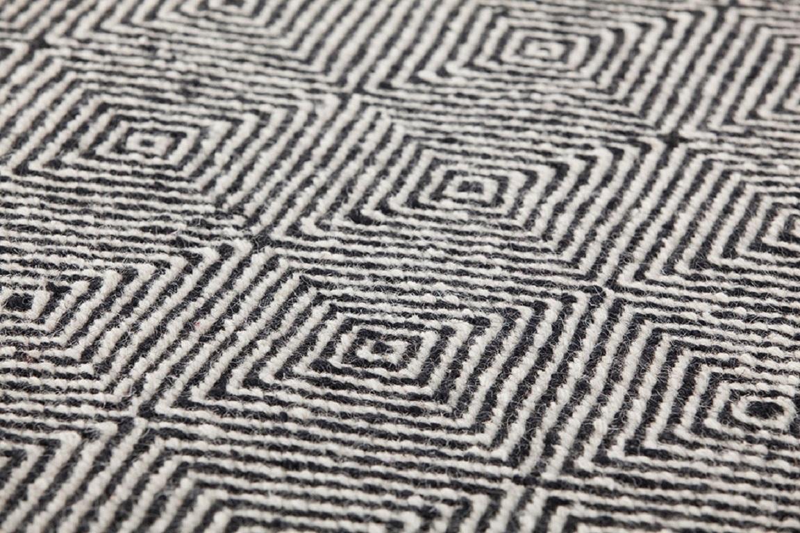 Dhurrie wool is transformed and grows in volume. Urban, sober and essential, it reveals myriad new possibilities.

Additional information:
Material: Jute. 100% wool. Reversible
Color: Black
Technique: Dhurrie
Dimensions: 118 W x 158 D x 0.39 H