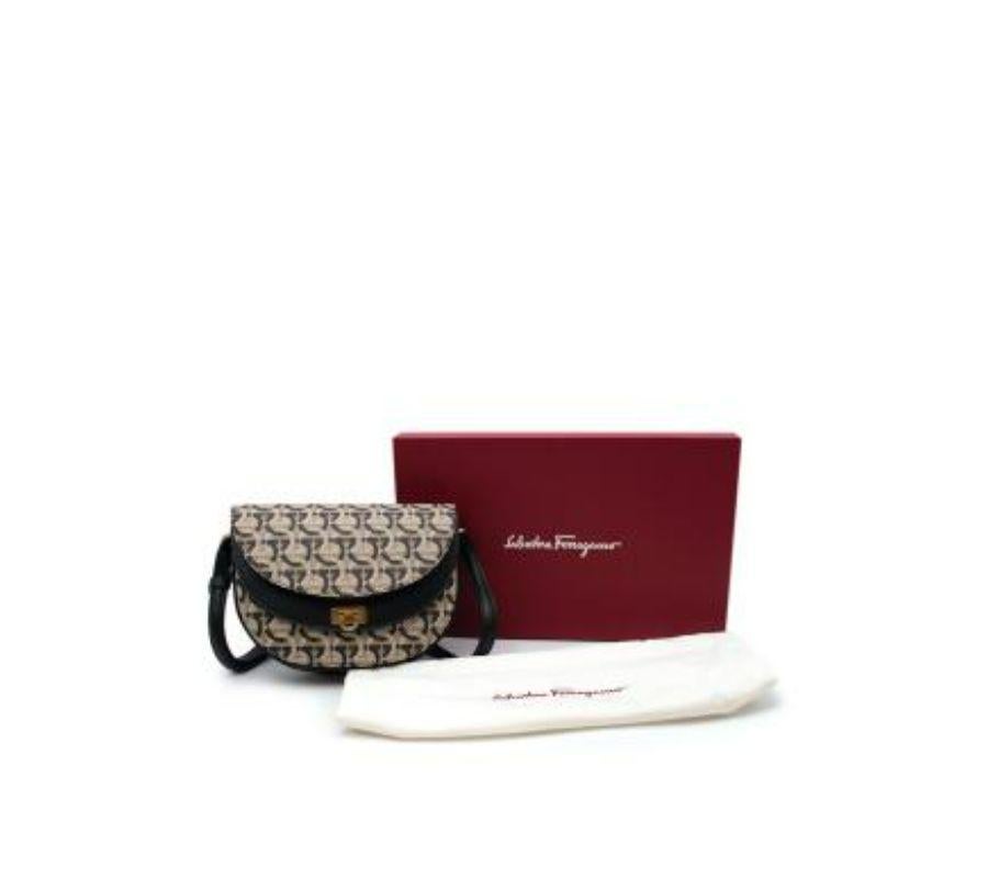 Salvatore Ferragamo Gancini Print Canvas Saddle Bag
 
 - Half-moon shaped crossbody style with 3 sculpted compartments
 - Signature Gancini clasp in gold-tone metal
 - Lined in black leather
 - Adjustable strap
 
 Materials
 Canvas
 Leather
 
 Made