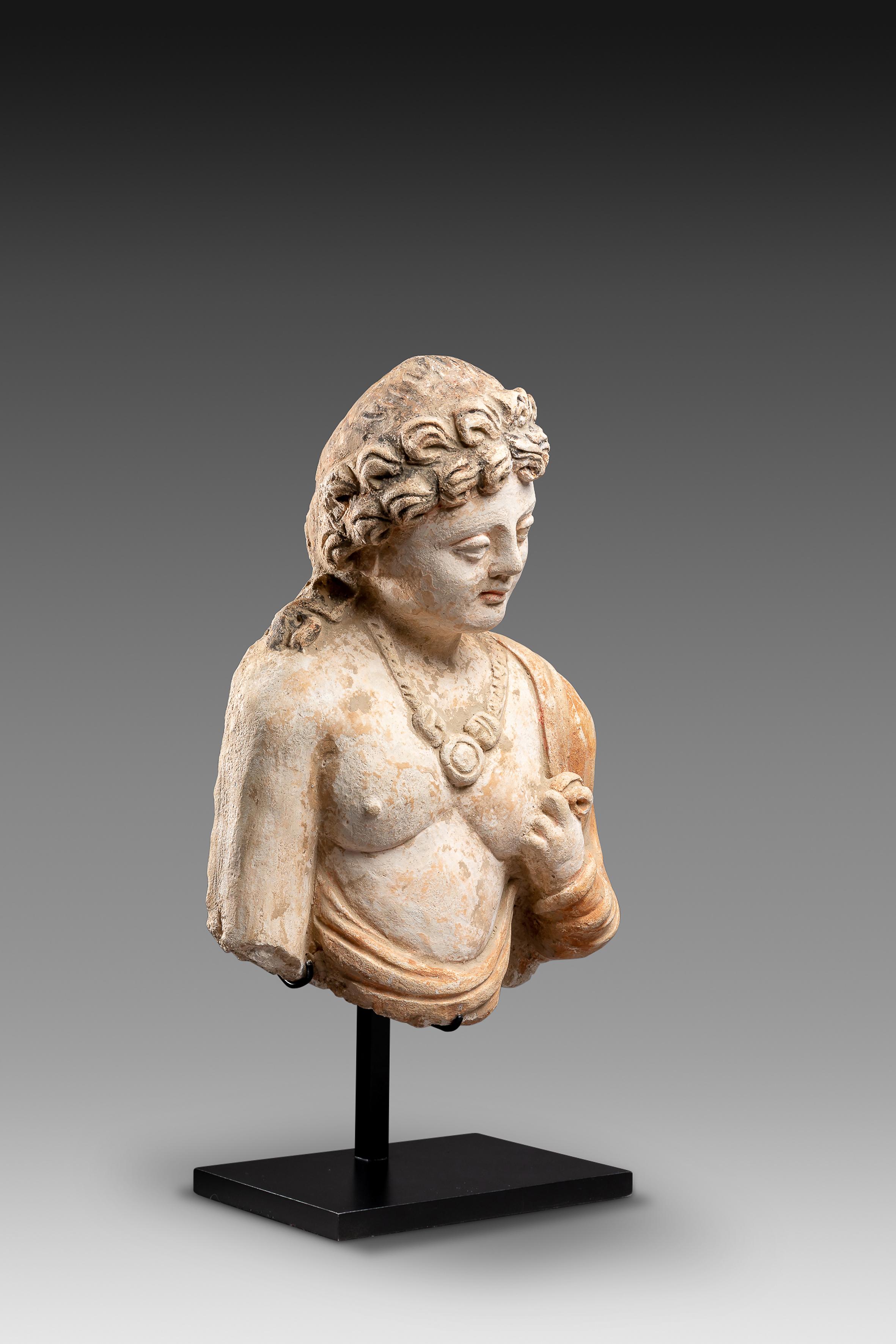 Gandhara Art

The childish looking face with round cheeks and luscious lips is marked by a sweet melancholic expression which we can recognize, in a Buddhist context, an infinite sadness given the human condition, as well as the profound devotion