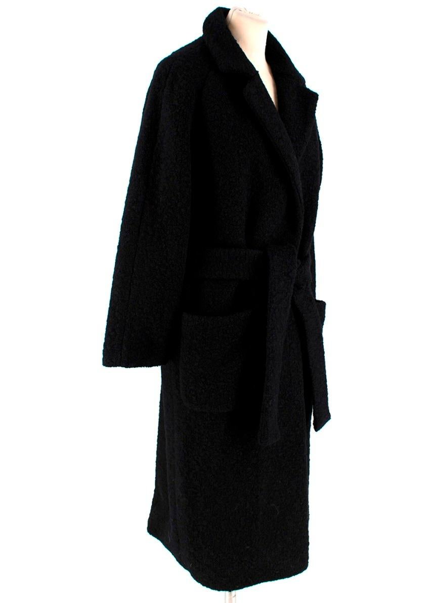 Ganni Boucle Fenn Long Coat Black

- Black boucle wool blend 
- Wrap style
- Concealed front press-stud fastening 
- Front patch pockets 
- Notched collar
- Tie belt waist  

Materials: 
Main - 50% Wool, 50% Polyester
Lining - 100% Polyester Sateen