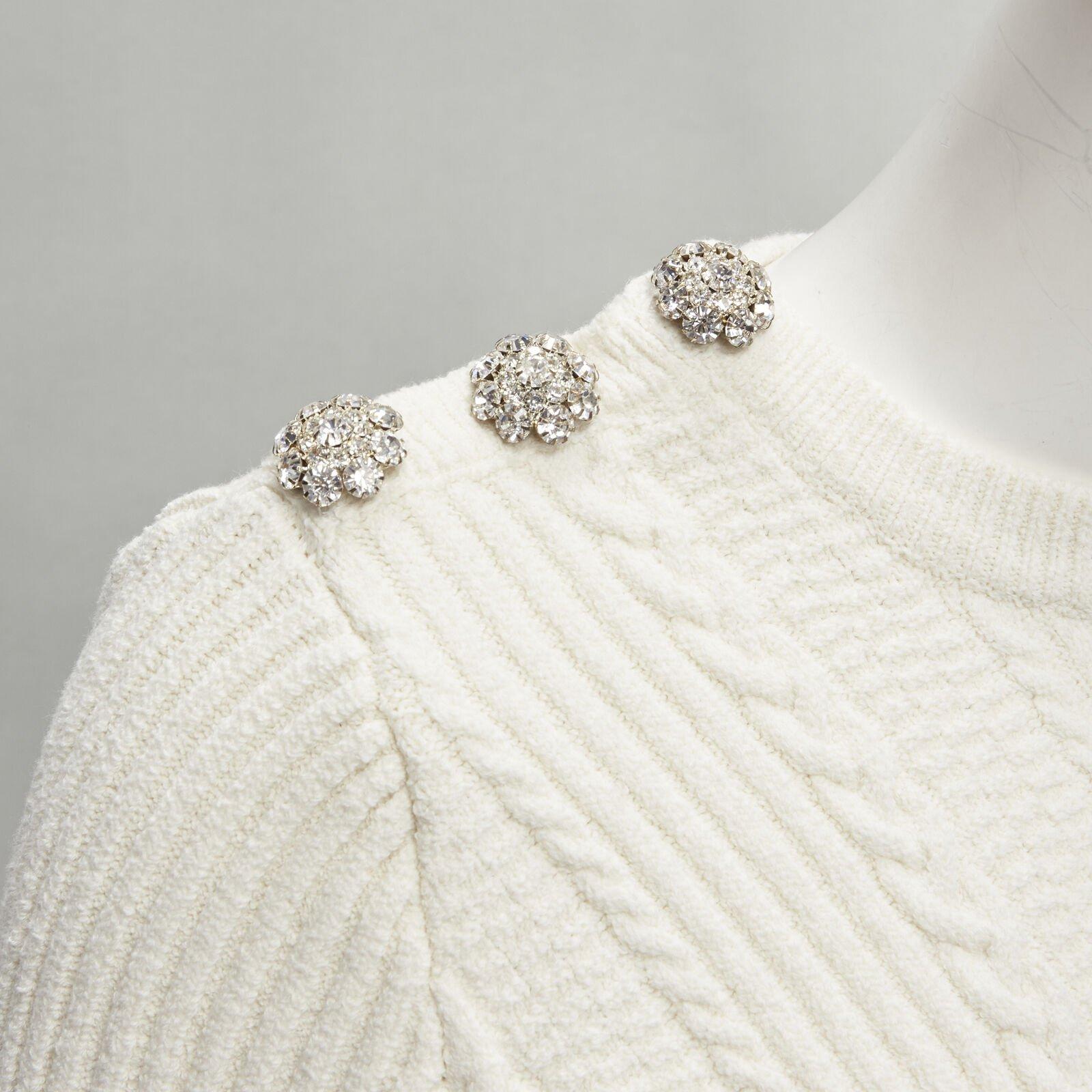 GANNI ivory crystal button textured knit cotton blend sweater top XS
Reference: AAWC/A00227
Brand: Ganni
Material: Cotton, Blend
Color: Ivory
Pattern: Knitted
Extra Details: Crystal buttons on right shoulder.
Made in: China

CONDITION:
Condition: