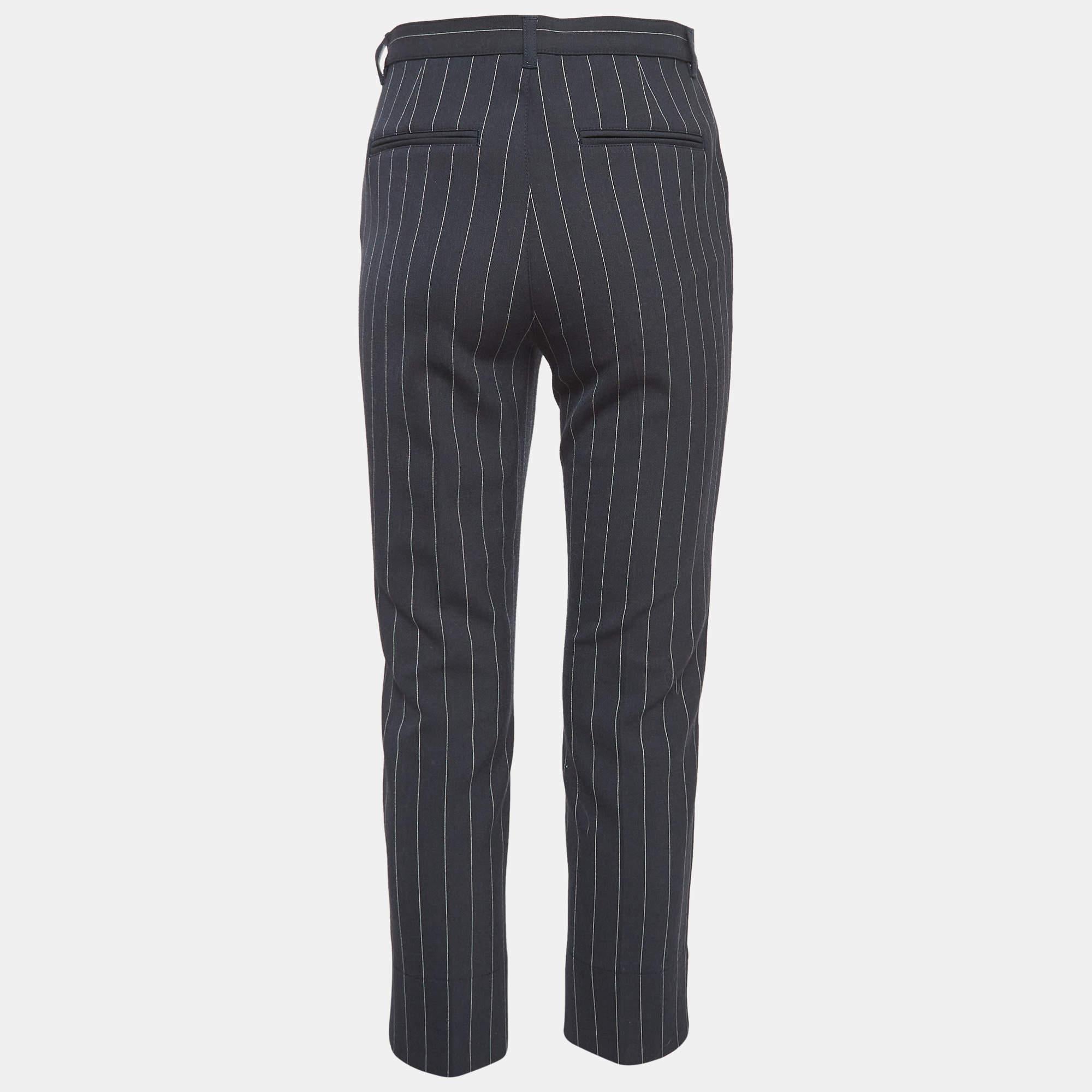 Crafted from soft crepe fabric these Ganni formal pants offer a polished look with a tailored fit. The subtle pinstripe design adds a touch of refinement making them perfect for both office wear and evening events. A versatile piece that blends
