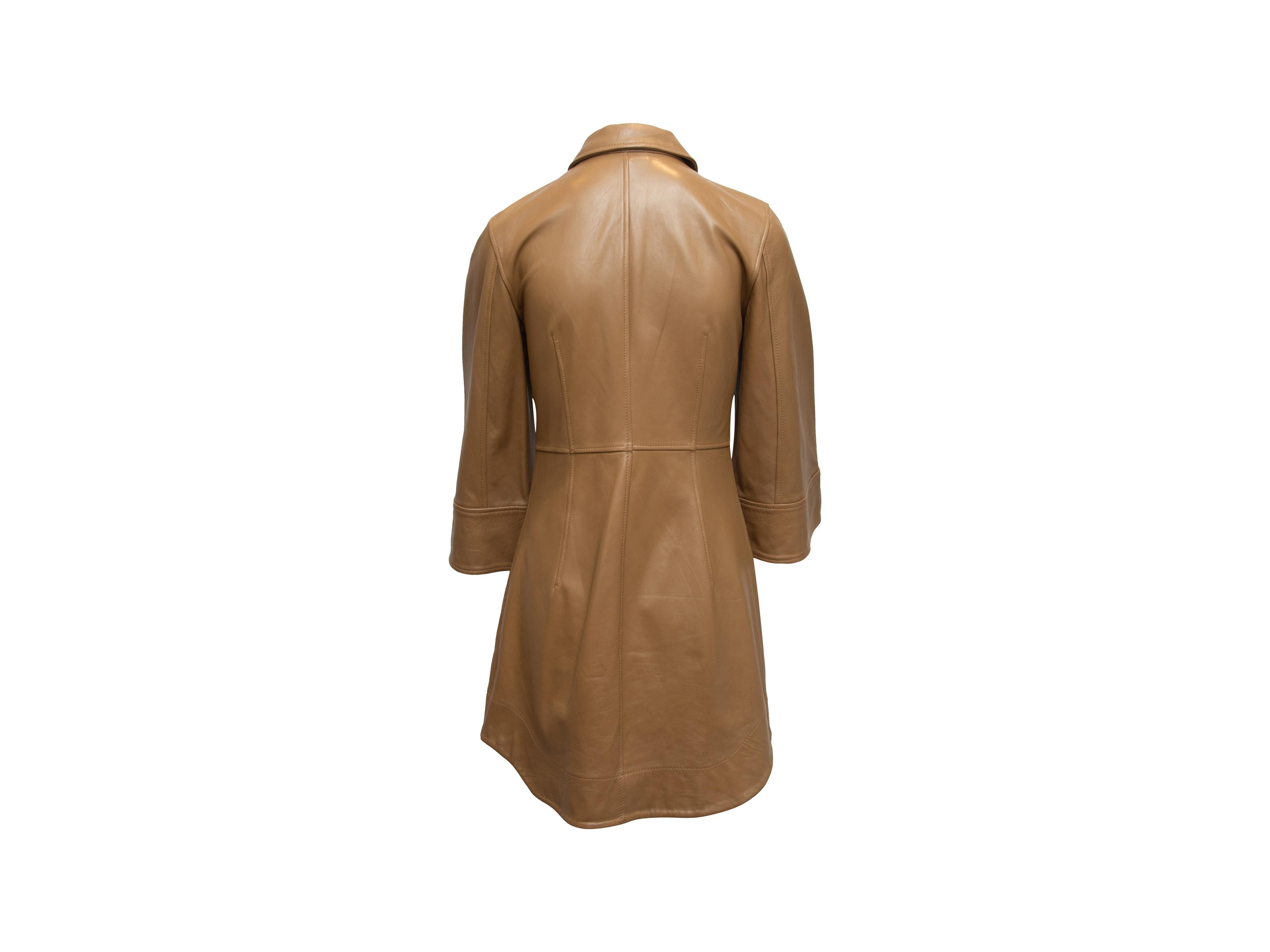 Product details: Tan leather mini dress by Ganni. Pointed collar. Three-quarter sleeves. Closures at front. 32