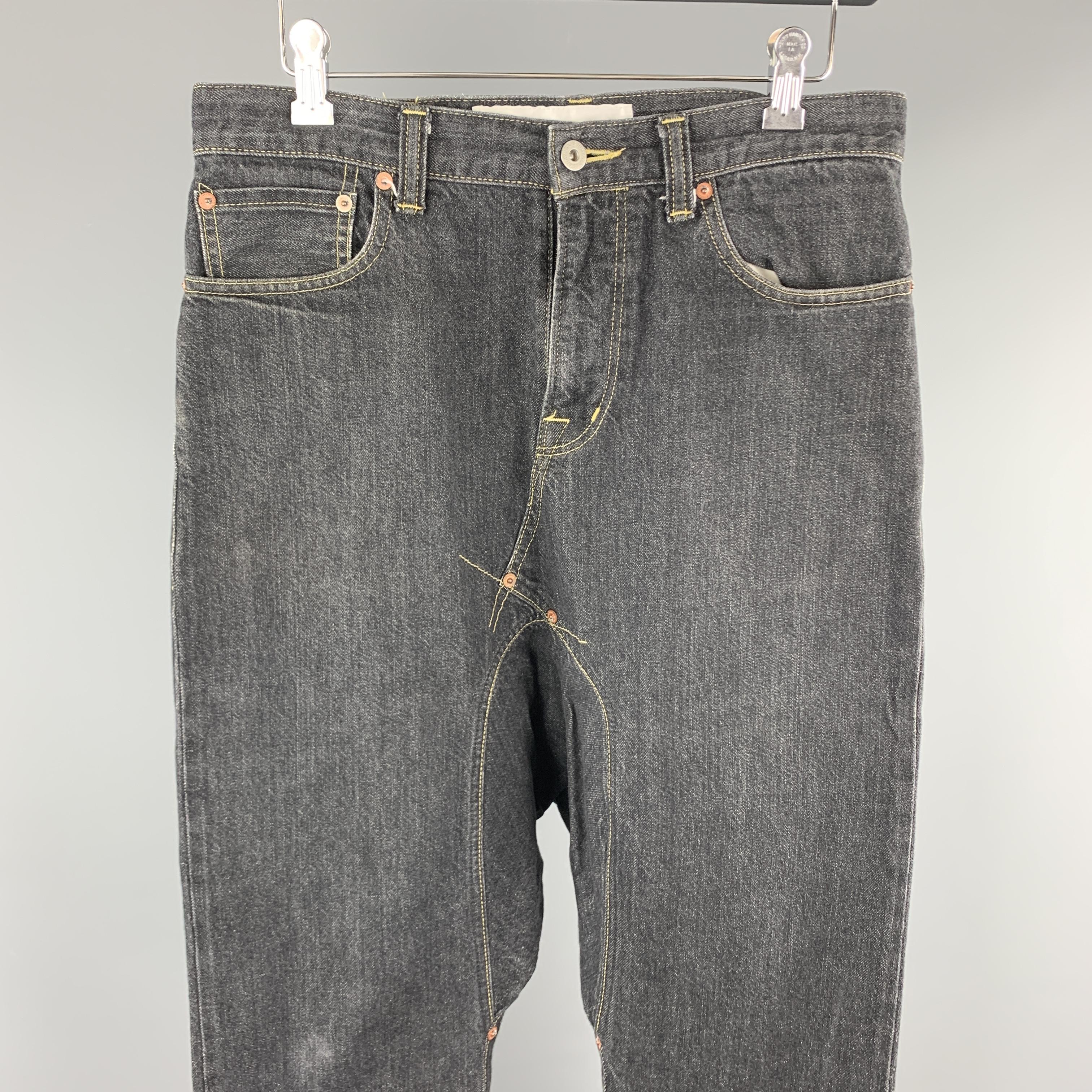 GANRYU by COMME des GARCONS jeans comes in a charcoal cotton featuring a drop crotch style, contrast stitching, and a zip fly closure. AD2015. Made in Japan. 

Excellent Pre-Owned Condition.
Marked: S

Measurements:

Waist: 31 in. 
Rise: 10 in.