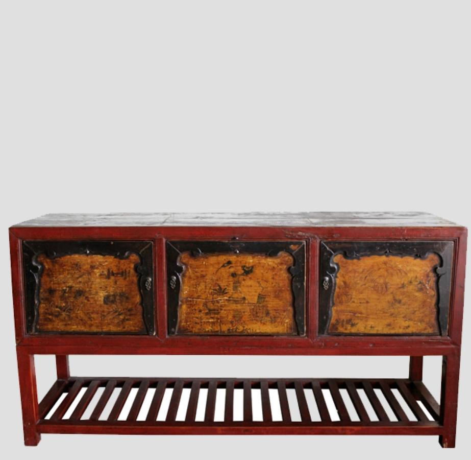 This antique farm table was retrieved from Gansu, China. The painting on three doors with carved borders is still original. The bottom shelf was add-on. This table is suitable as a living room console table, sideboard, credenza cabinet or dining