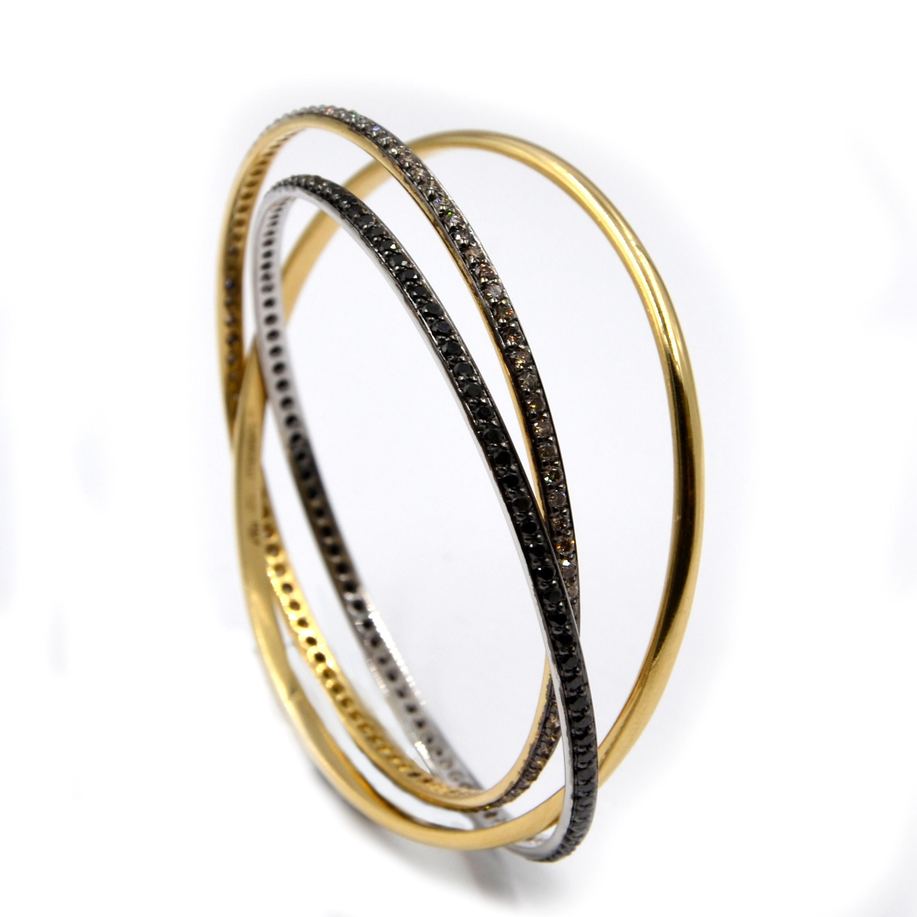 Garavelli 18 Karat Yellow Gold Black Brown Diamonds Rolling Bangle Bracelet
slip on bracelet diameter mm 60 
thickness mm.4 each band
GOLD gr : 42.02
BROWN DIAMONDS ct : 2,75
BLACK DIAMONDS ct : 2.98