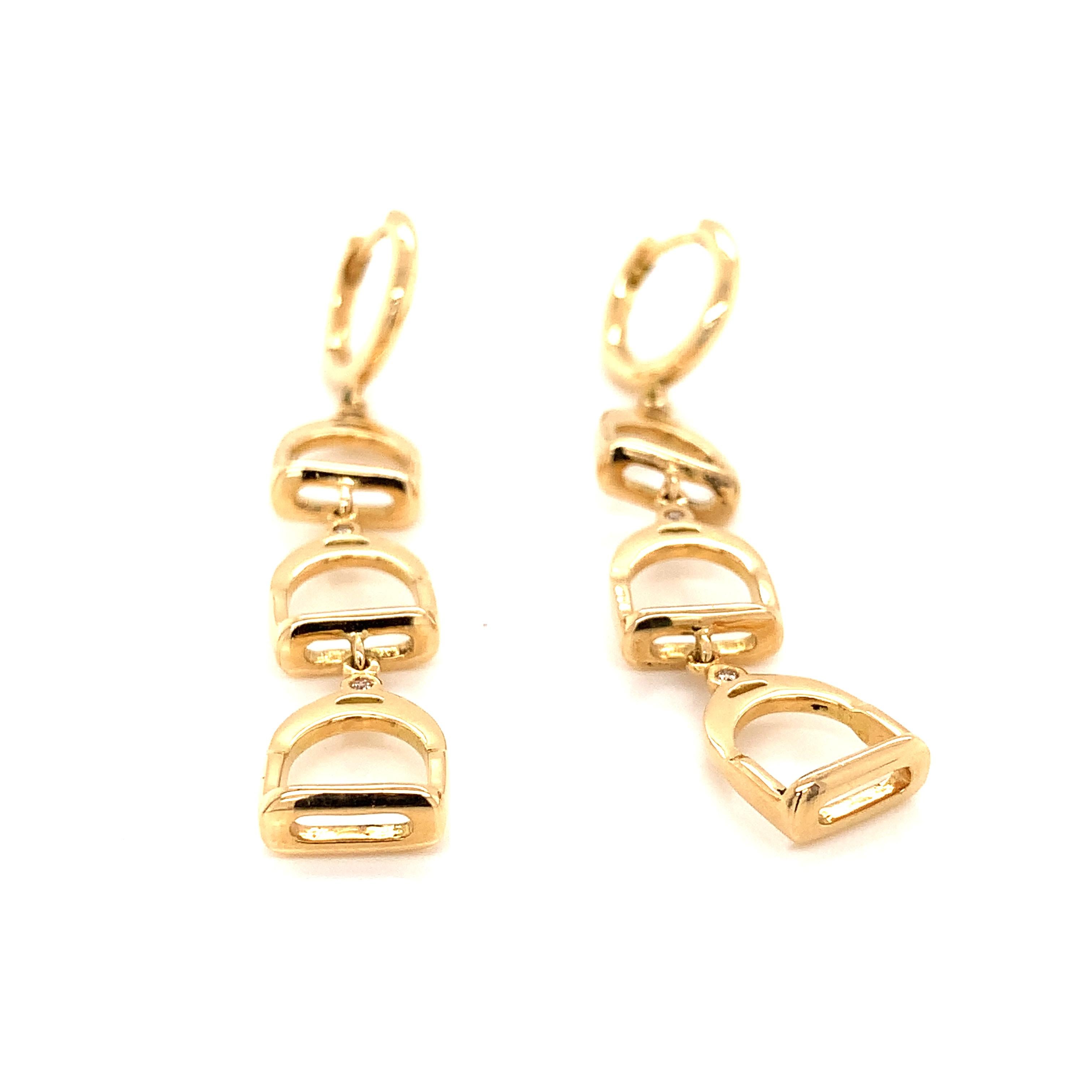 Garavelli 18 Karat Yellow Gold  Dangling Earrings from Staffe Collection, featuring diamonds accents. Made in Valenza, Italy
Each stirrup is 15mm tall and have one diamond.
Total earrings length mm 60 
18kt YELLOW GOLD  : gr 9.90
Brown diamonds ct