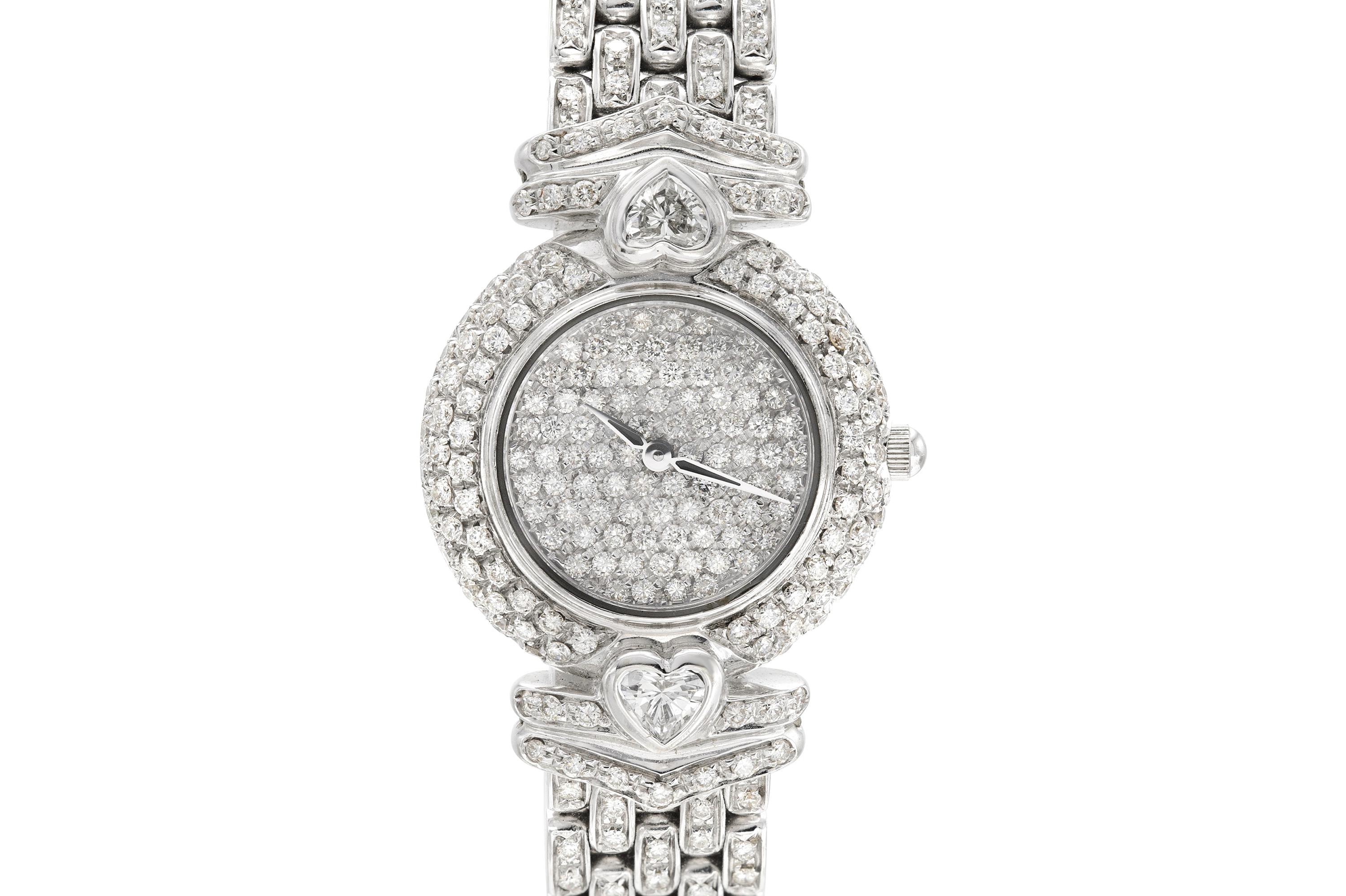 Finely crafted in 18k white gold with two Heart-shaped diamonds weighing a total of 0.80 carats and round brilliant cut diamonds on the face, the dial, and the band, weighing approximately a total of 4.00 carats.
Quartz, 23mm dial
Signed by