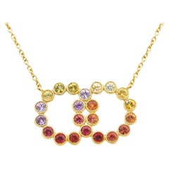 Garavelli Double Circle Pendant in 18 Kt Yellow Gold with Rainbow Sapphires Garavelli Double Circle Pendant in 18 Kt Yellow Gold with Rainbow Sapphires