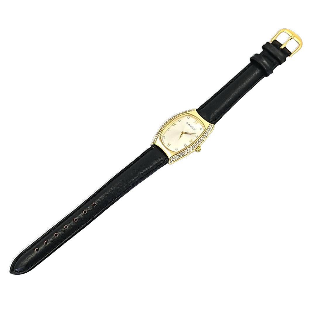 Pre-Owned Garavelli Quartz Watch Crafted in an 18 Karat Yellow Gold Tonneau Case Shape. The Diamond Bezel Contains 84 Round Brilliant Cut Diamonds of VS Clarity and G Color Totaling 0.63 Carats. Black Calfskin Strap with Tang Buckle. Finished Weight