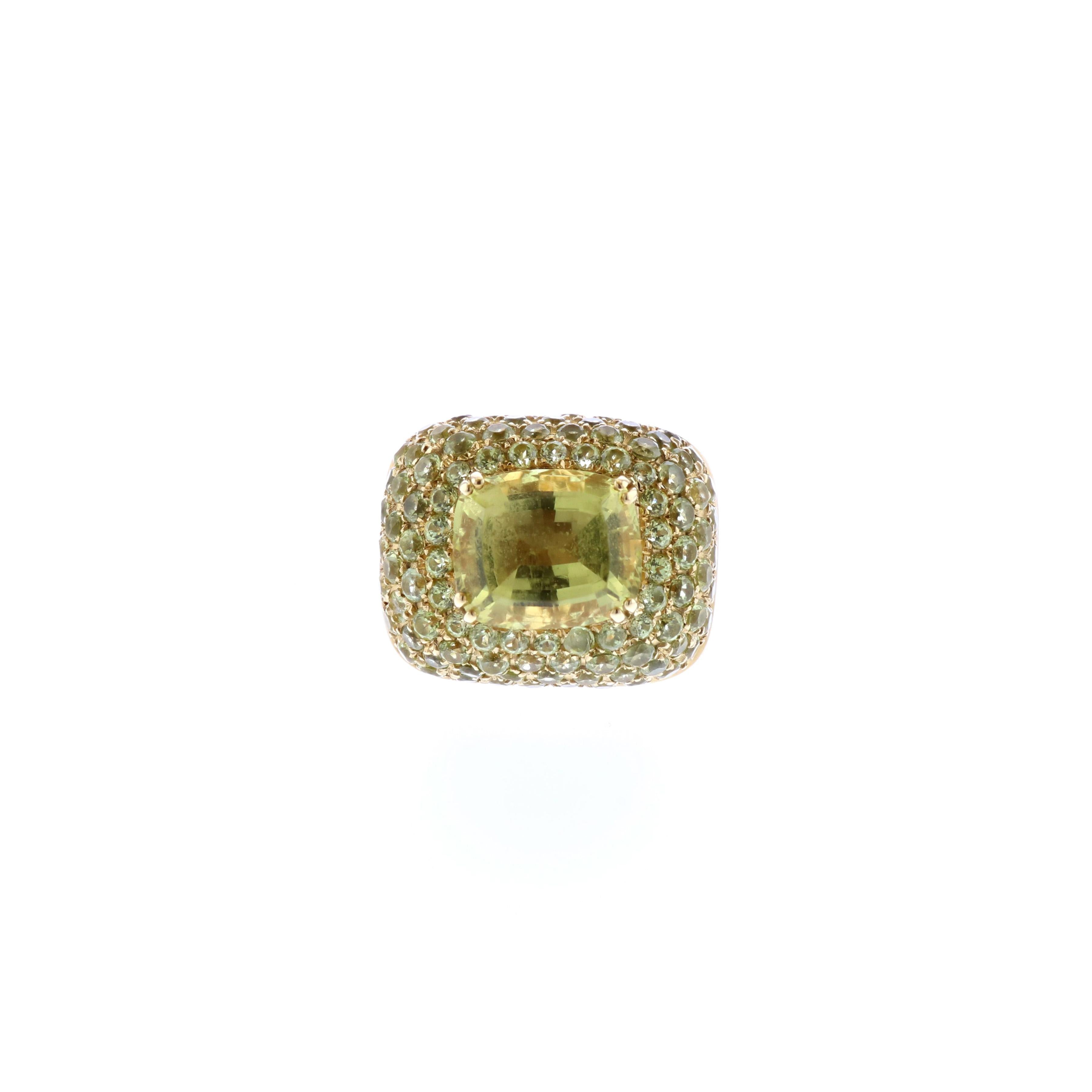 18K yellow gold ring with citrines.  The center stone is a cushion cut citrine weighing 4.65 carats.  Surrounding it are 100 round citrines with total carat weight of 2.25.  The ring is currently a size 7.  Measures 1-1/16