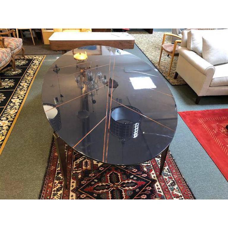 A stunning new mesa dining table from Garbarino, Monte Carlo. The oval table has glossy ink lacquer inset with walnut Canaletto. Handcrafted in Italy. The table's gamine legs are galvanized in bronze. Original Price: $13,140.

 