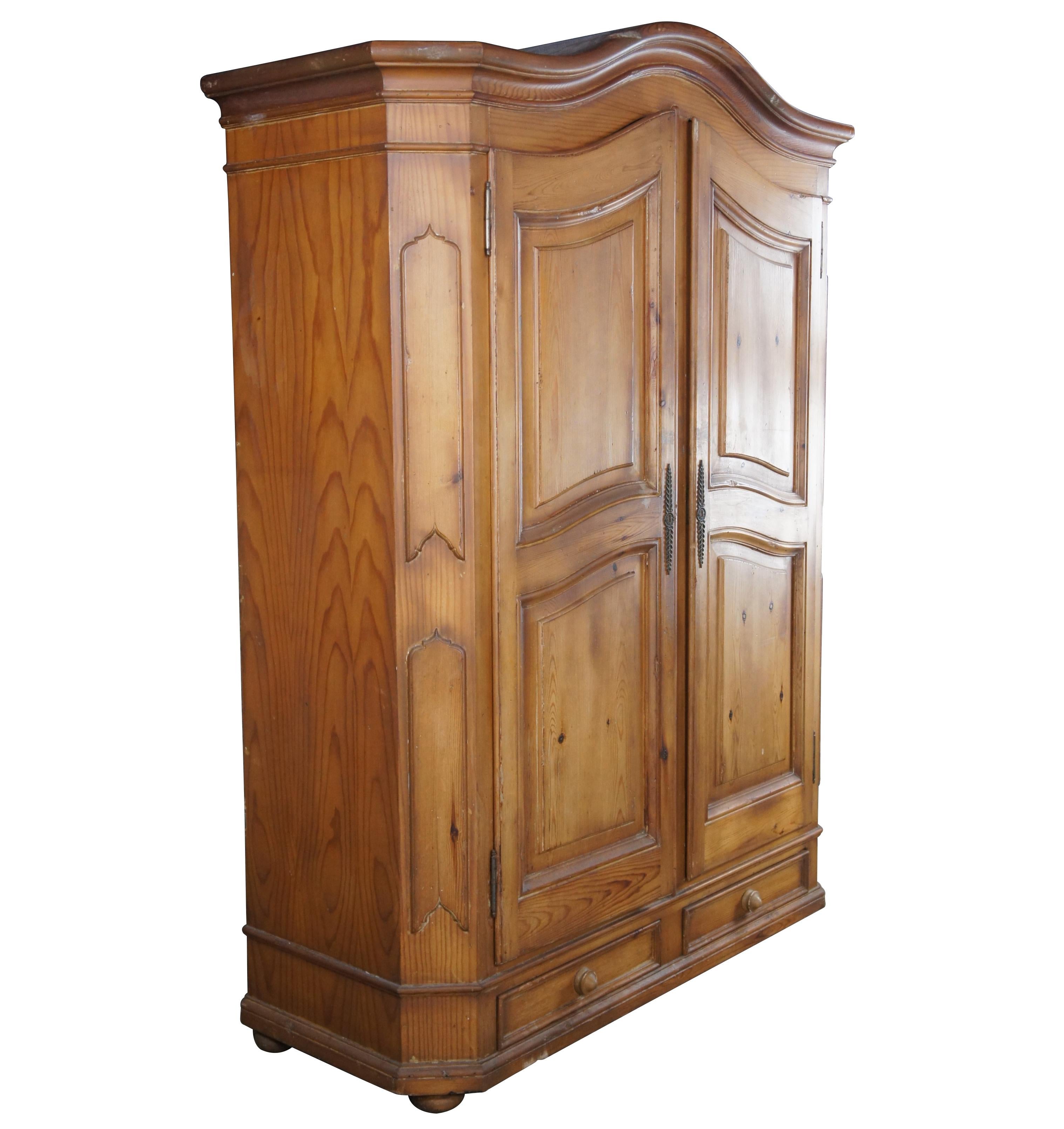 An exquisite armoire from Garcia Imports. Made in Spain from a distressed pine. Includes a chifforobe setup with hanging bar along the left, 3 interior shelves to the right and lower drawers with a key for locking. Garcia specializes in reproducing