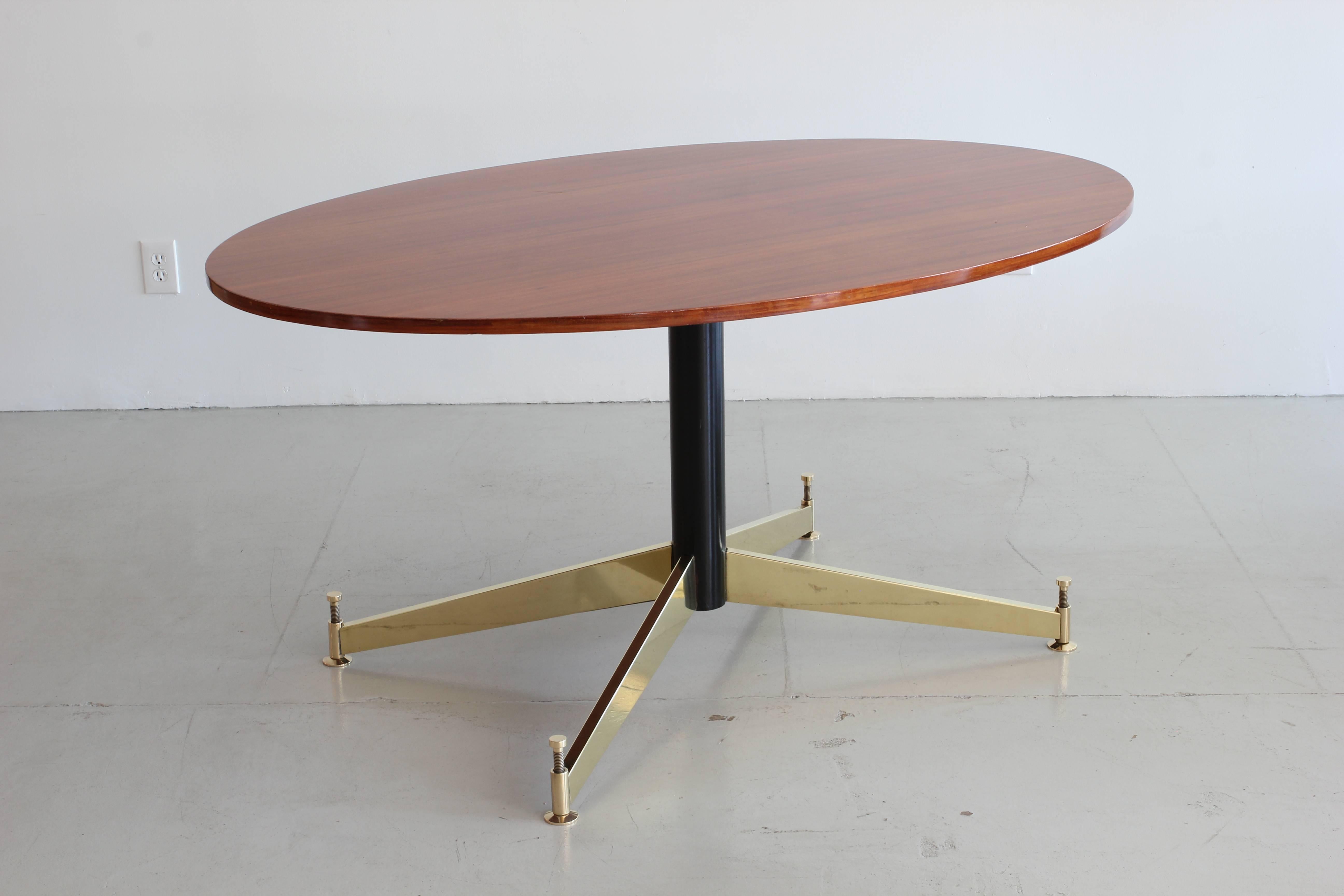 Beautiful Italian oval rosewood table with brass base by Ignazio Gardella for Azucena.
    