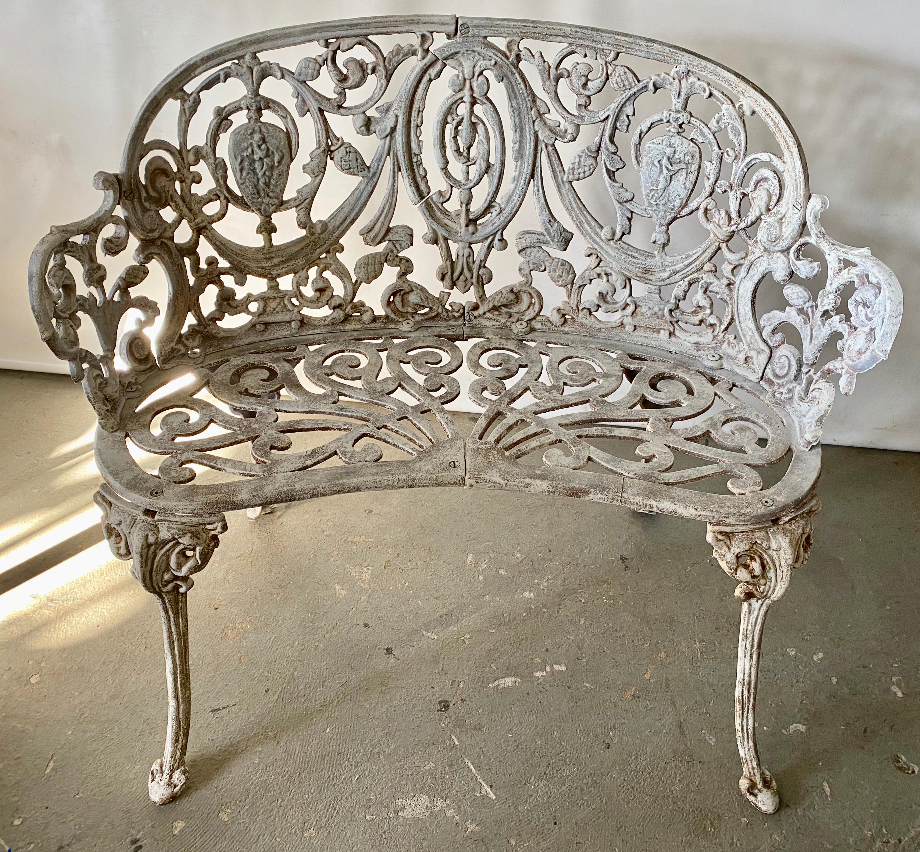 Cast iron Coalbrookdale style garden or patio bench painted white. Perfect for summer entertaining or morning coffee on a patio, front porch or garden. 
Search terms: Hollywood Regency style patio furniture, baroque styling, neoclassical, cast iron