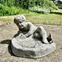 Garden Bird Bath with a Small Child Feeding the Birds