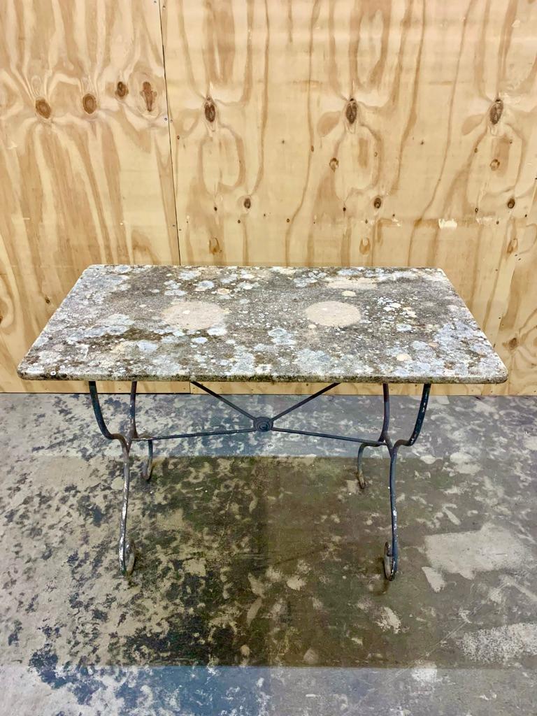 Antique French garden- or café table - with a fantastic weathered patina on the marble table top and wrought iron base.