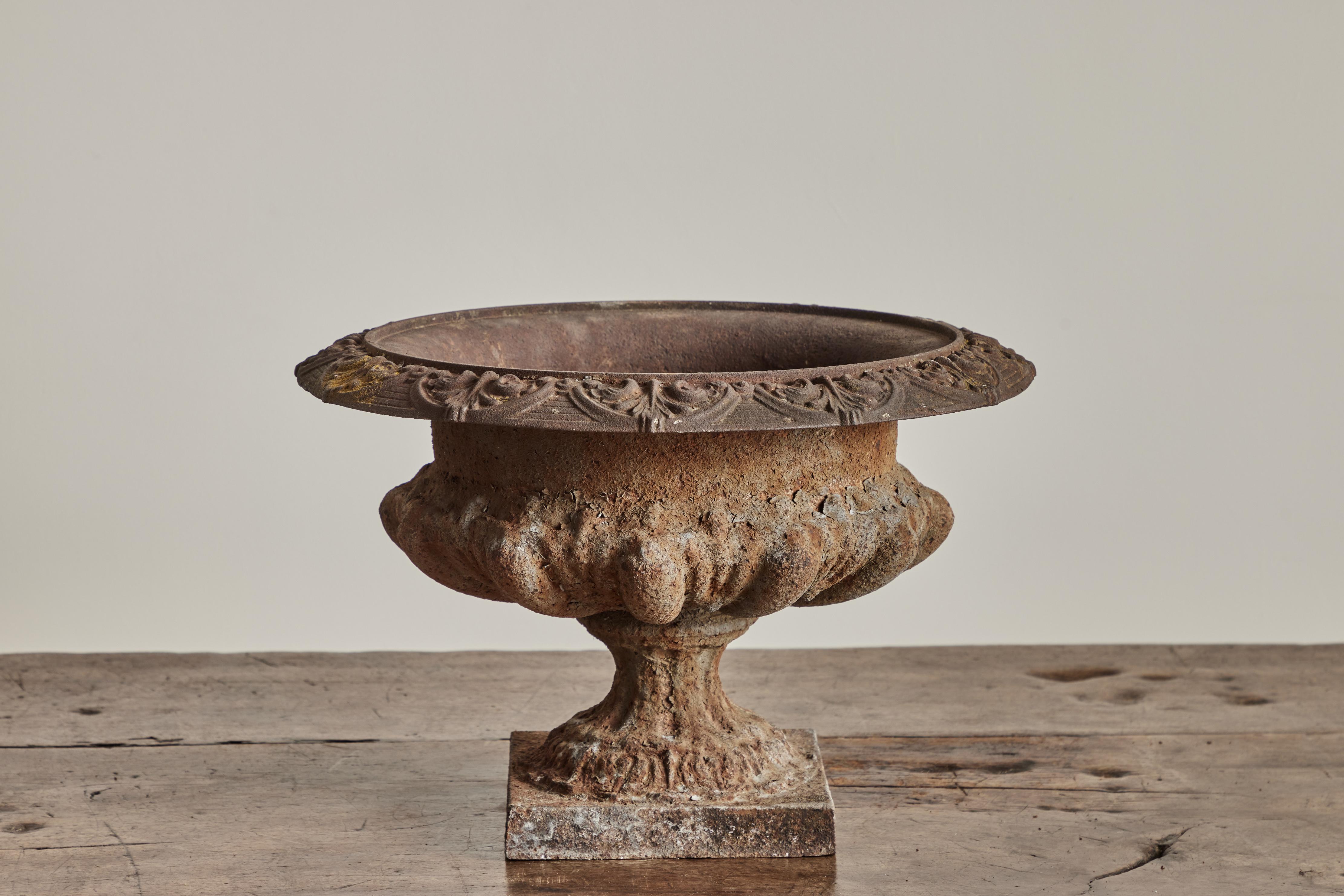 Antique cast iron garden urn circa 1900. Visible wear throughout on metal is consistent with age and use. Two urns received, each sold separately. This item requires white glove 
