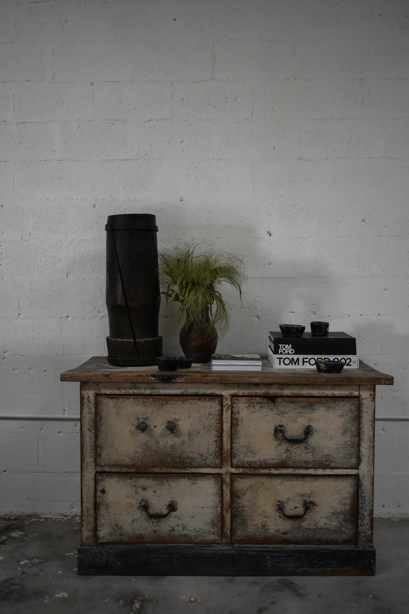 Garden commode, 19th century.

Wood painted counter, produced during the 19th century. Features four drawers with three simple hardware pulls and one wooden knob. 

Wear consistent with age. 