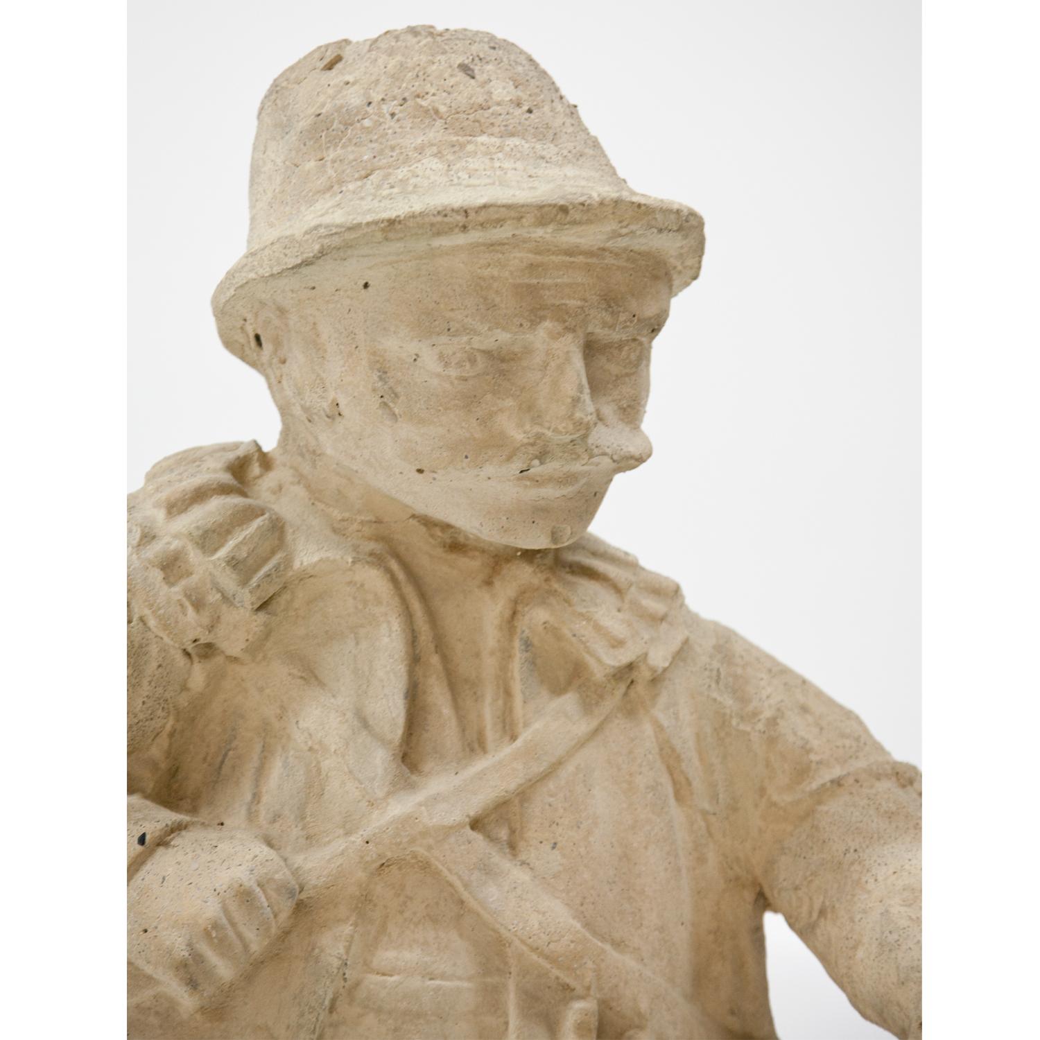 Garden figure of a hunter with rifle out of cast stone and painted beige.